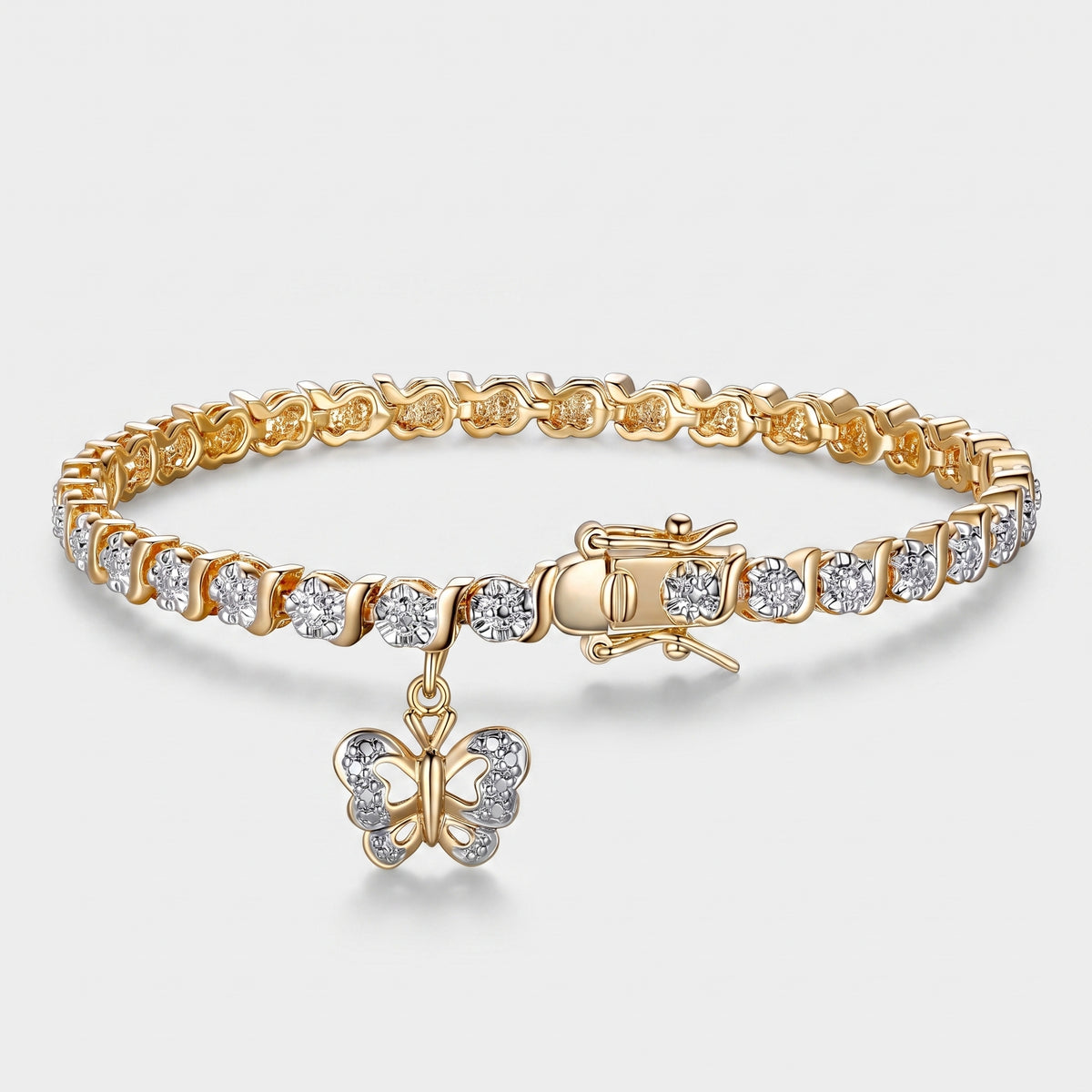A gold tennis bracelet with clear round-cut stones and a dangling butterfly charm, shown on a light gray background.