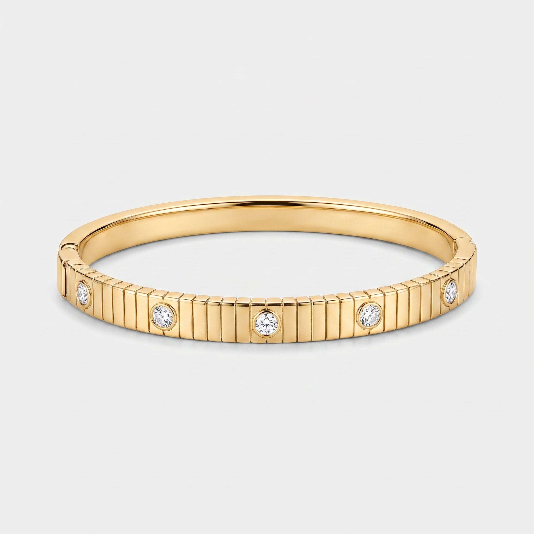 14K gold plated ribbed bangle bracelet with five bezel-set round cubic zirconia stones on a white background