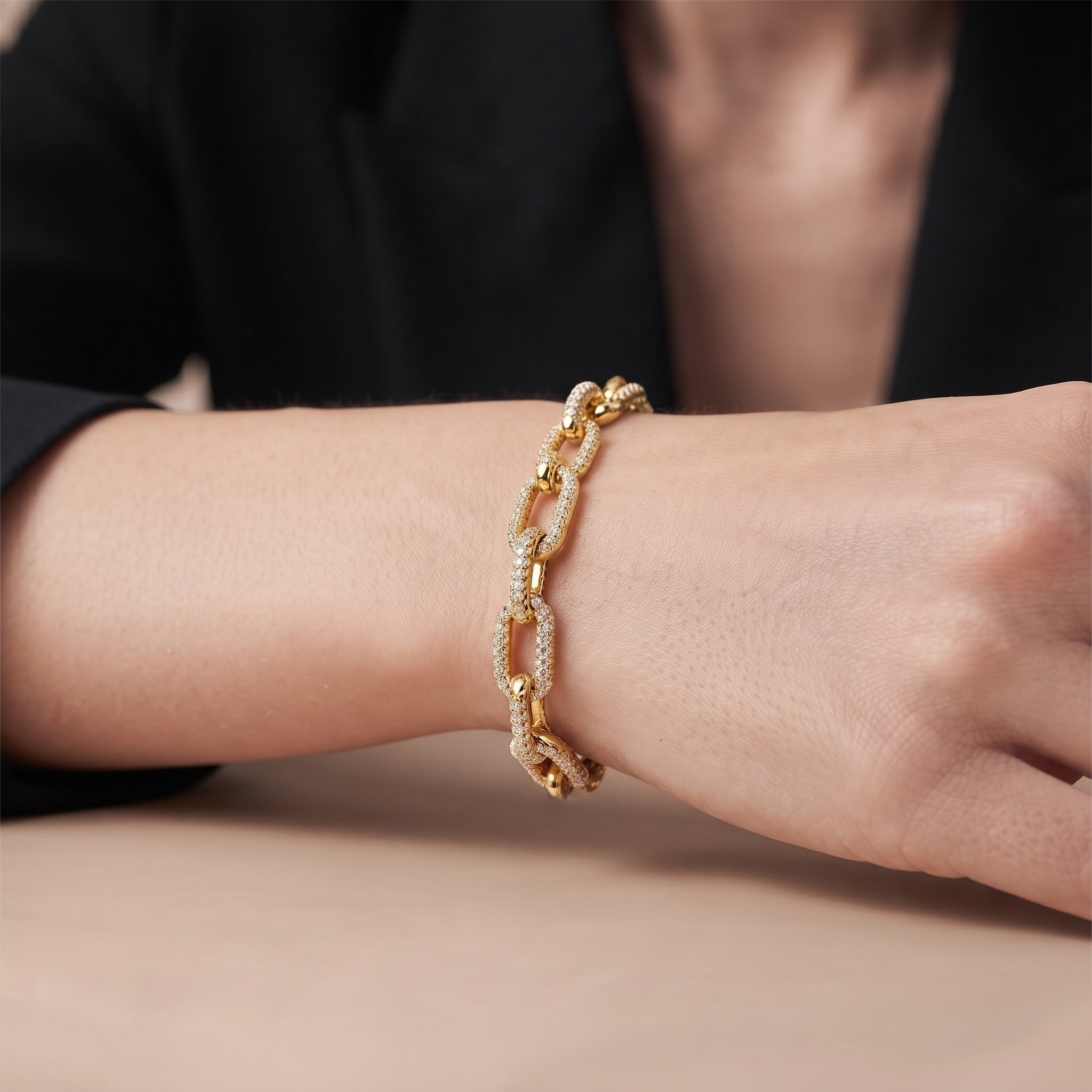 Close view of the pave cubic zirconia stones on the gold chain link cuff