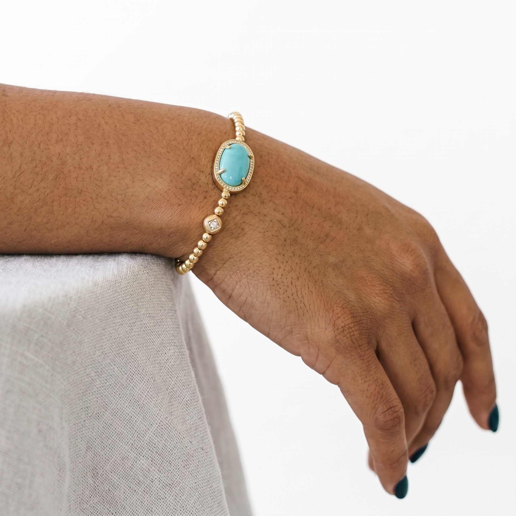 Blue magnesite stone bracelet on a gold bead band styled for everyday wear