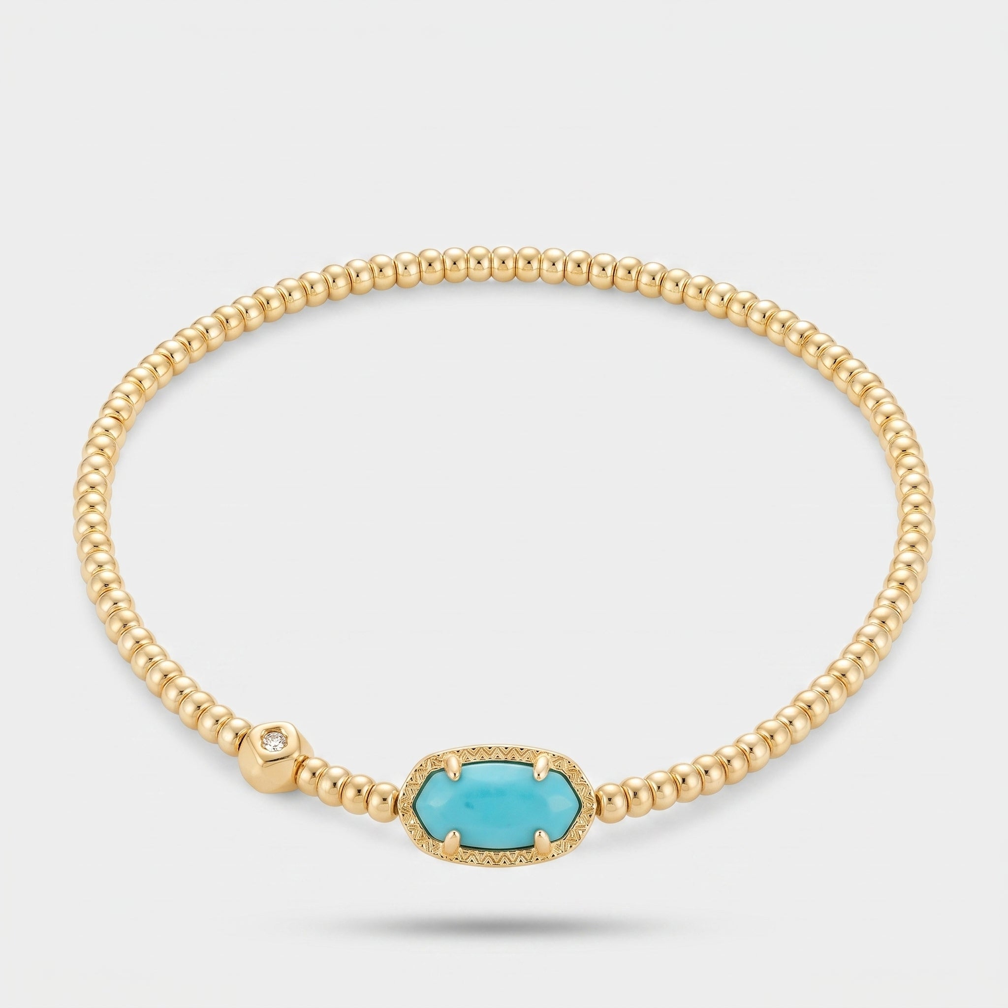 Turquoise magnesite gold beaded stretch bracelet with an oval blue stone