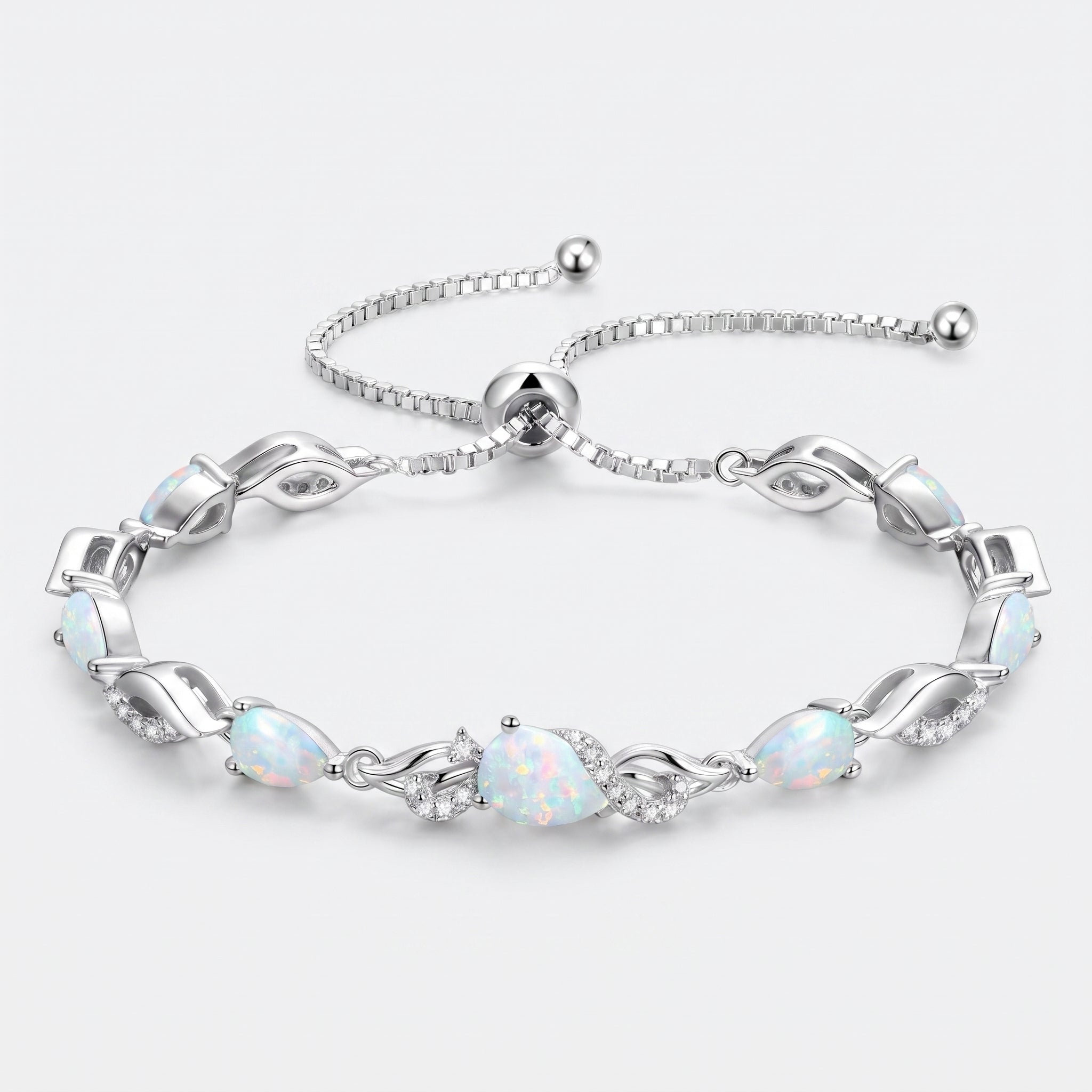 Opal teardrop tennis bracelet in sterling silver laid flat, showing the adjustable bolo clasp and leaf-link design.