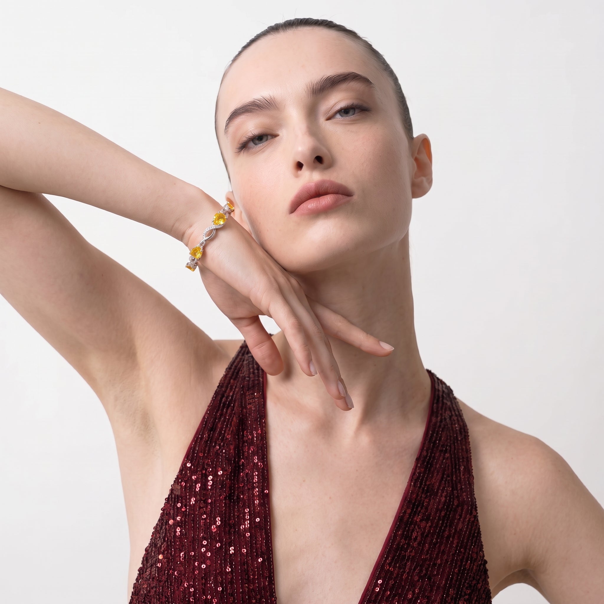 Woman wearing the citrine bracelet on her raised wrist, showing the full sparkle of the stones.
