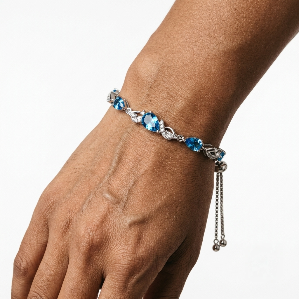 Close-up of a woman's wrist wearing the London blue topaz bracelet, showing the sparkle of each stone.