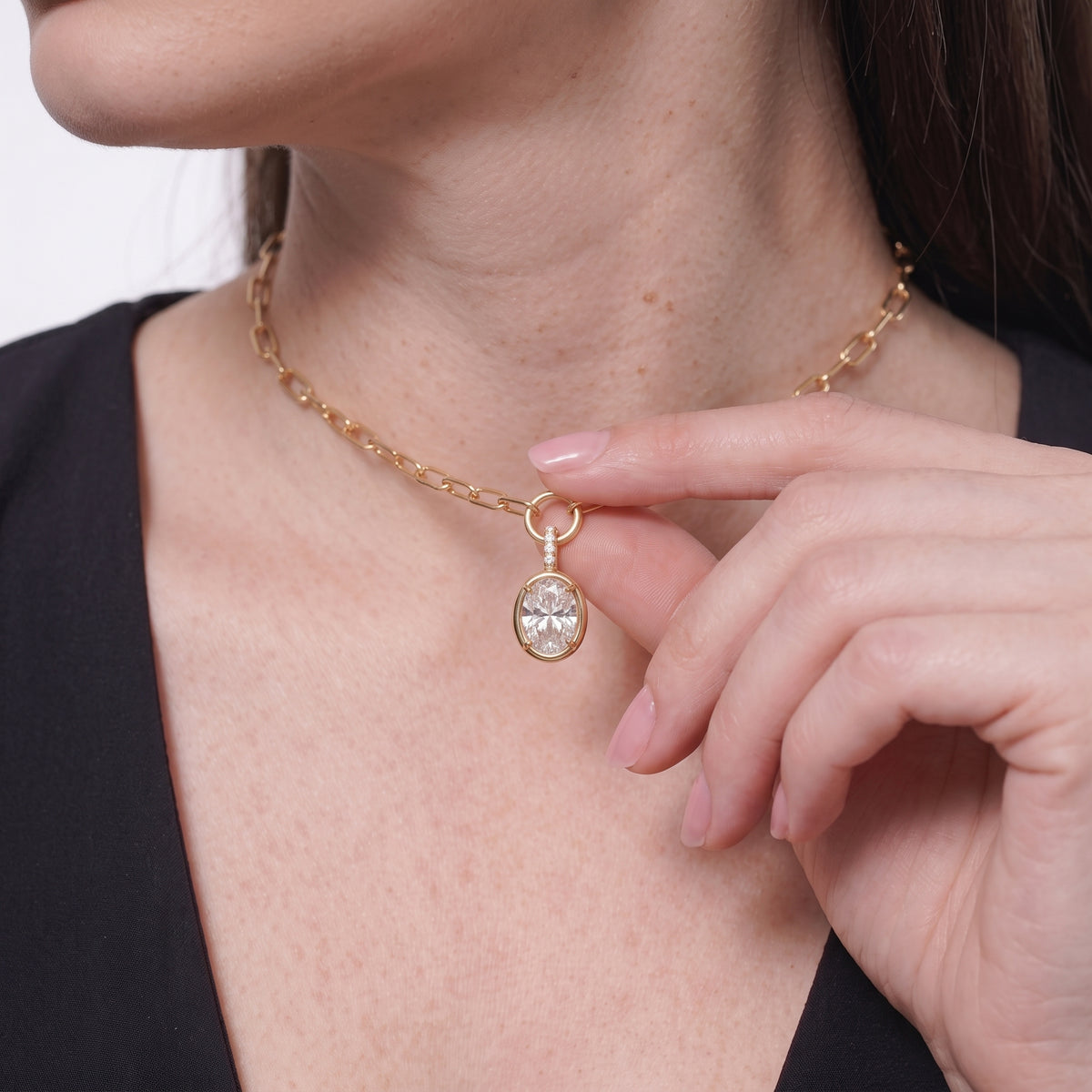 Side view of an oval CZ pendant necklace sitting just below the collarbone