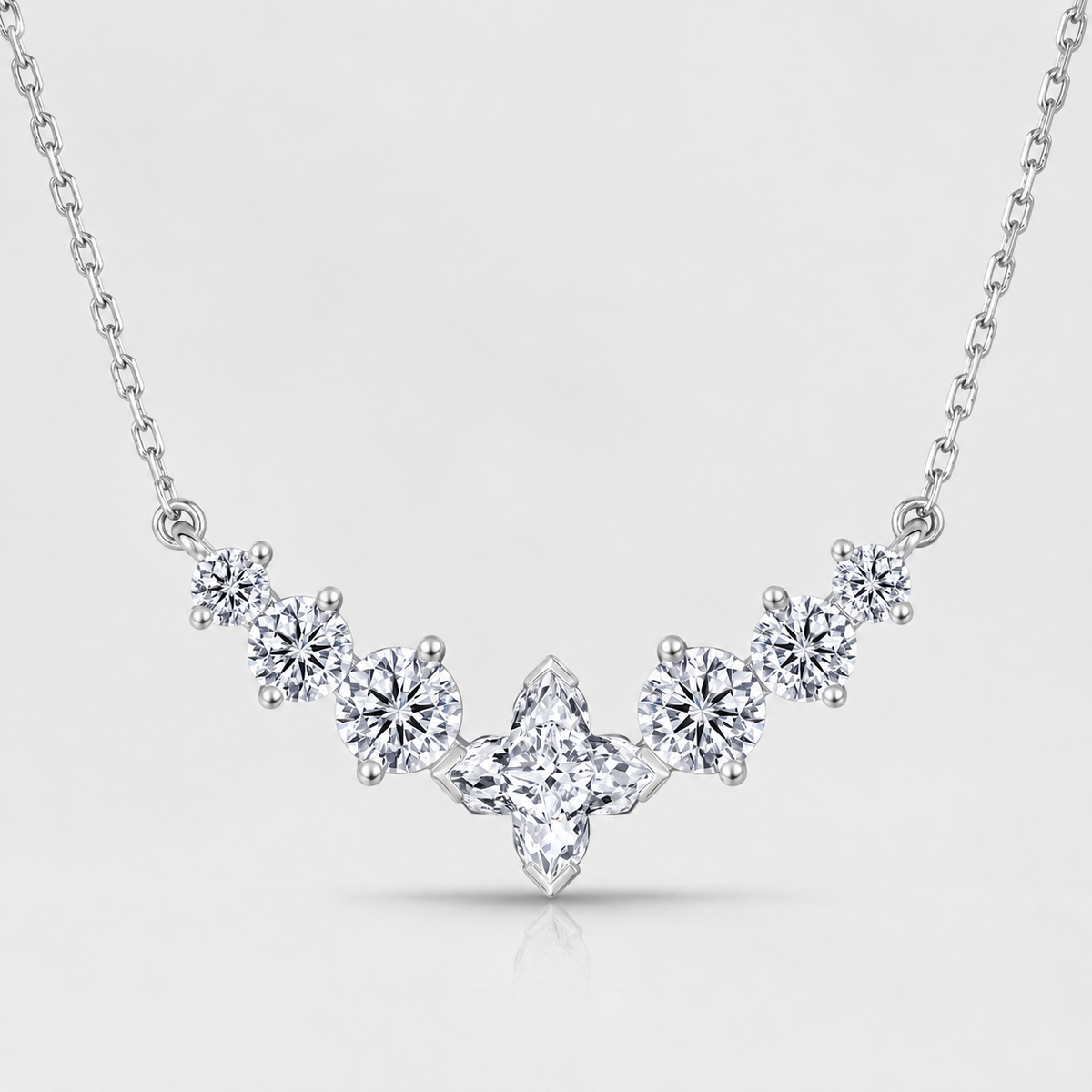 Sterling silver 7 stone moissanite necklace with stones in a soft V shape and a star shaped center stone