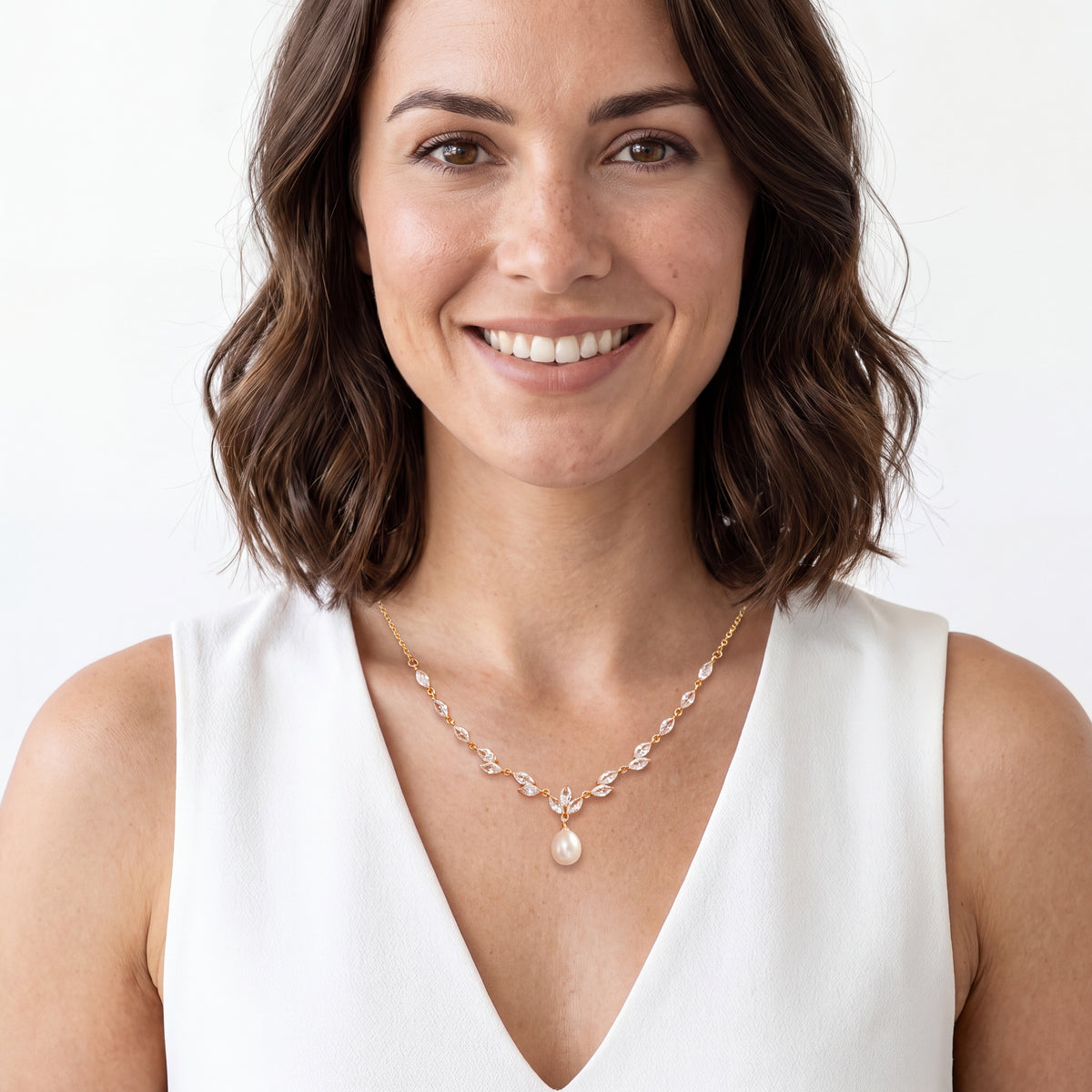 Woman wearing a gold CZ vine necklace with a teardrop pearl for a wedding or prom