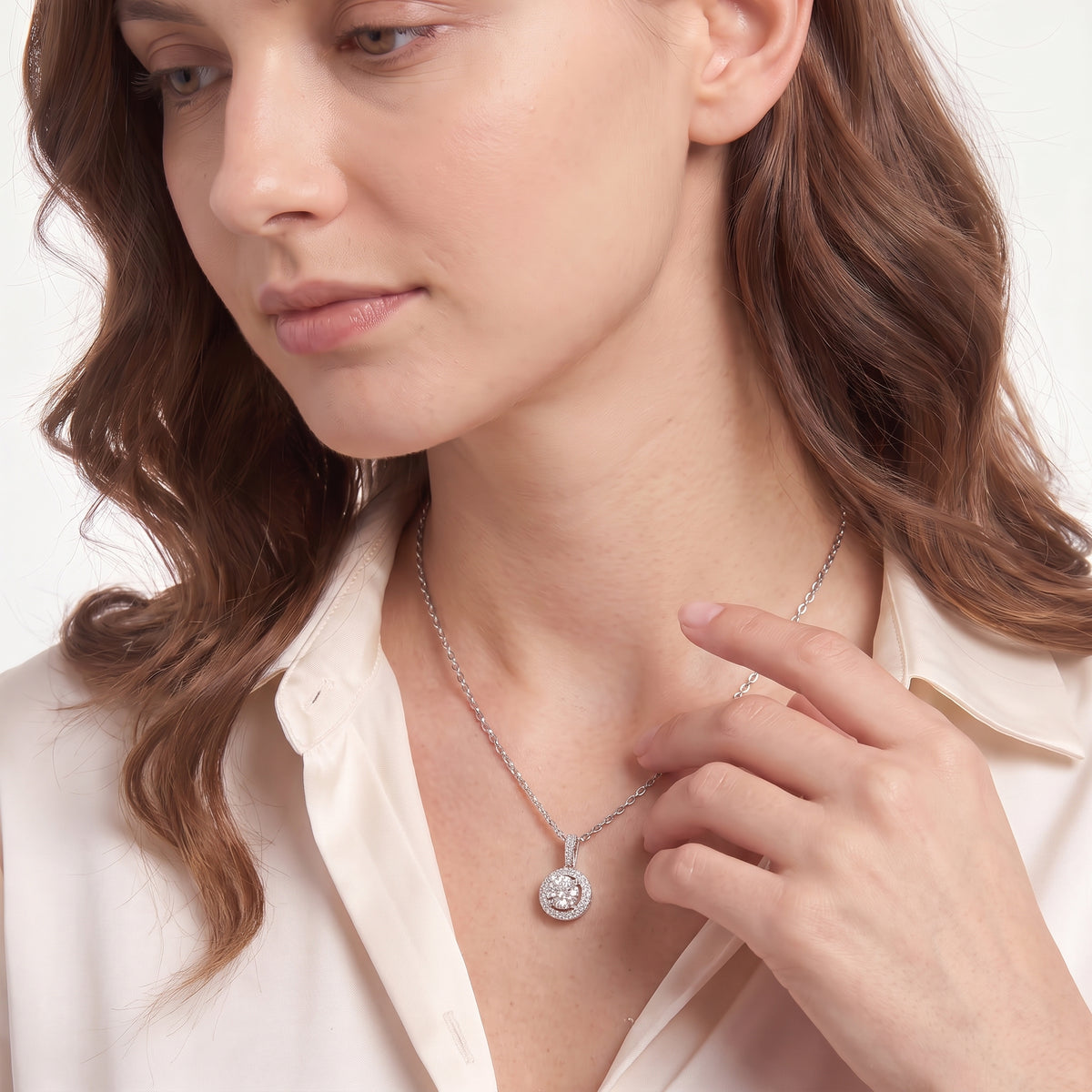 Close-up of a double halo moissanite pendant resting just below the collarbone