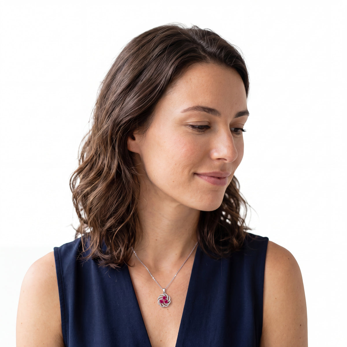 Side view of a woman wearing a July birthstone ruby pendant necklace