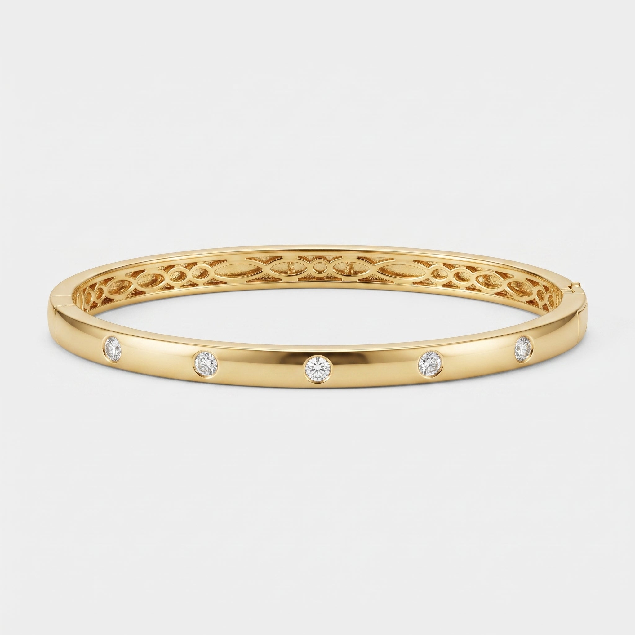 A yellow gold bangle bracelet with five small round-cut clear gemstones spaced evenly along the front band, set against a clean white background.