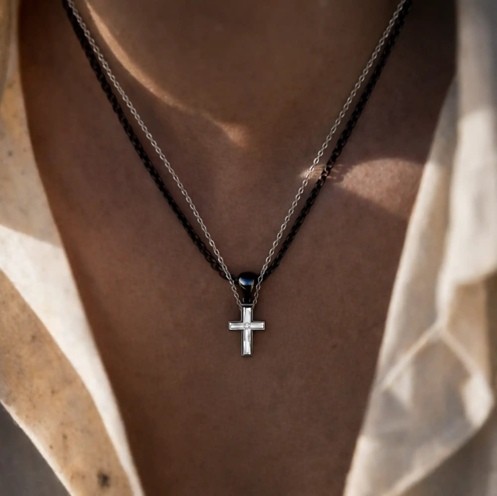 Close-up detail of 925 sterling silver cross couple pendant necklace set.