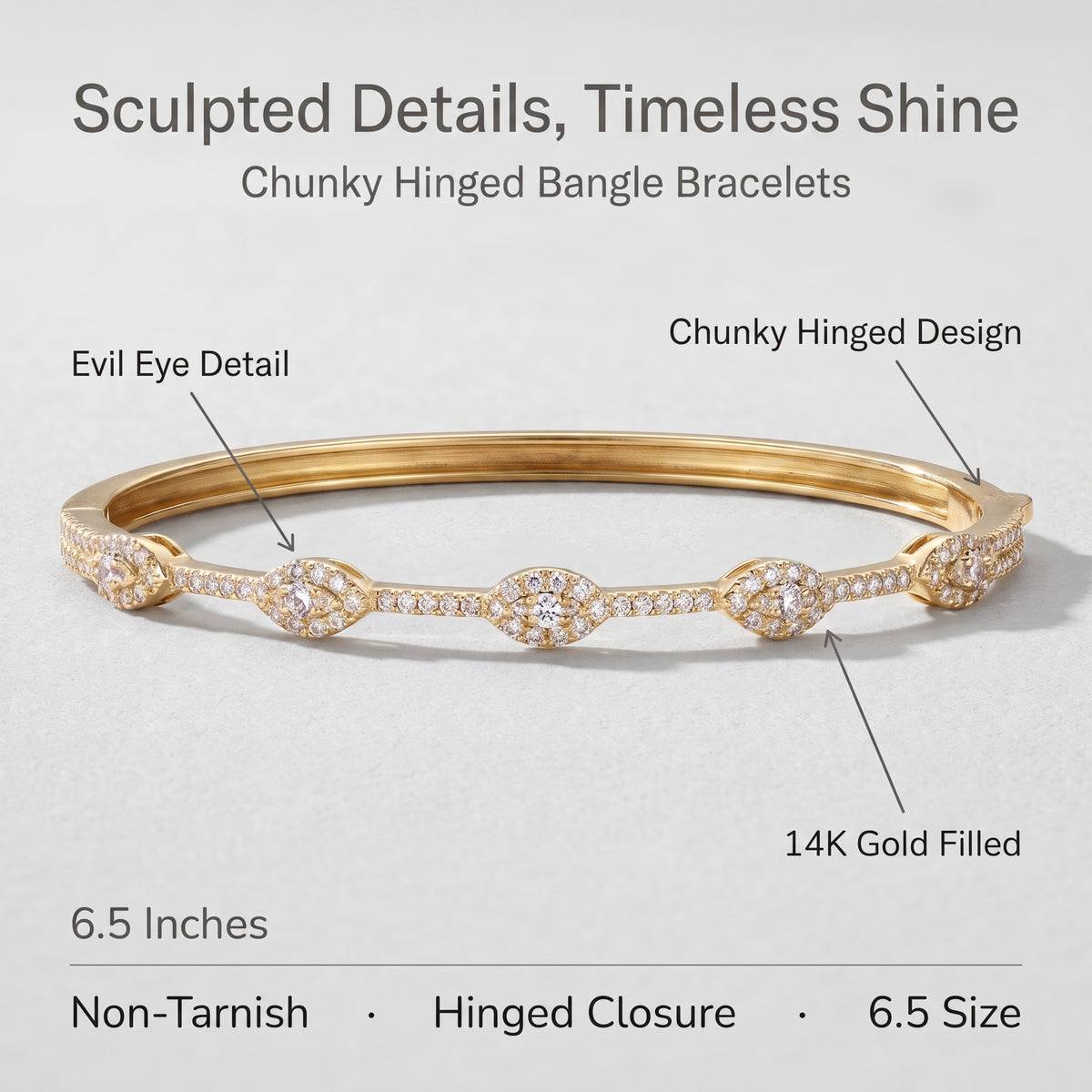 A gold bangle bracelet with diamond accents, shown on a light gray background with text callouts describing its chunky hinged design, evil eye detail, 14K gold fill, and 6.5-inch size.
