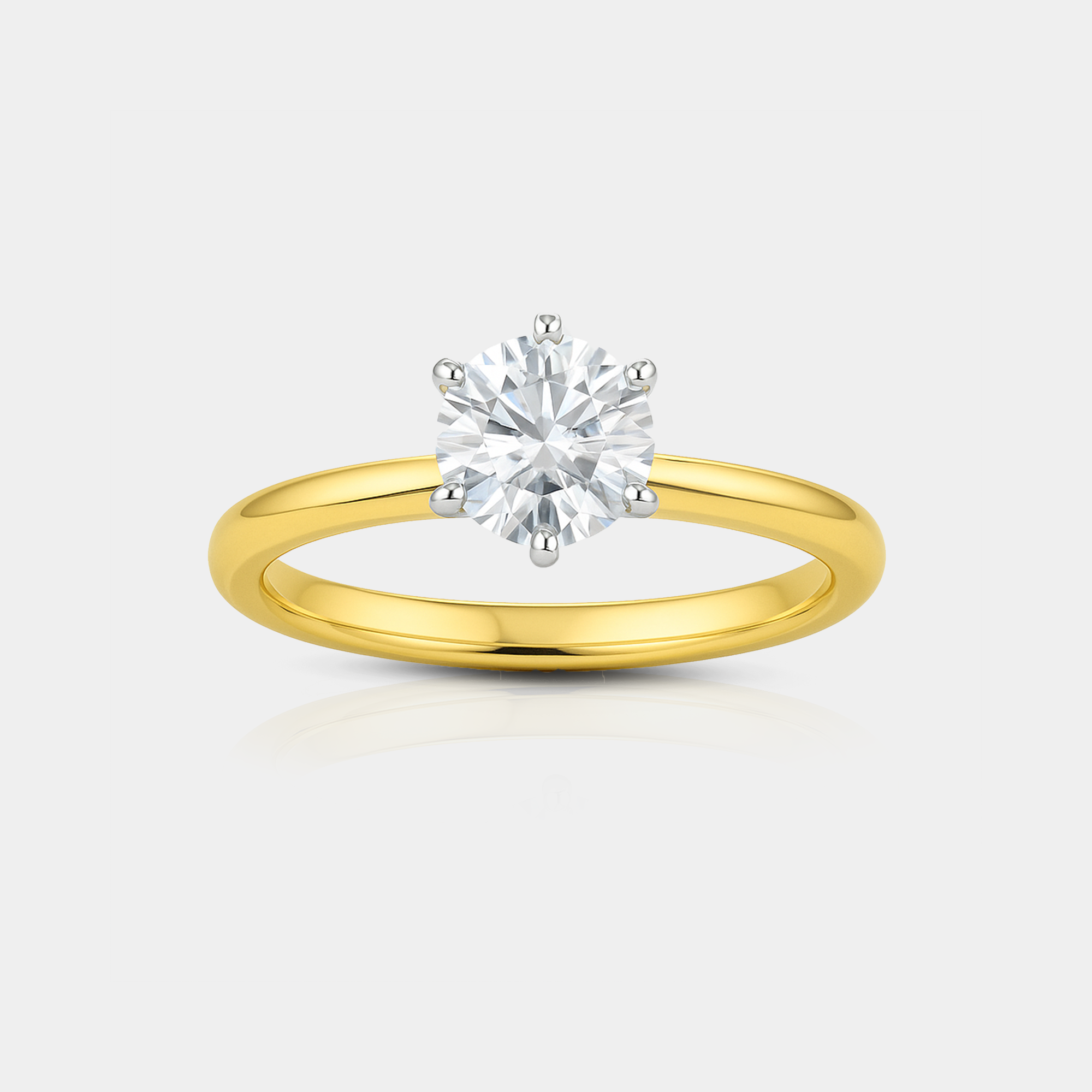 Classic solitaire moissanite engagement ring in 14K gold with round brilliant stone on white background