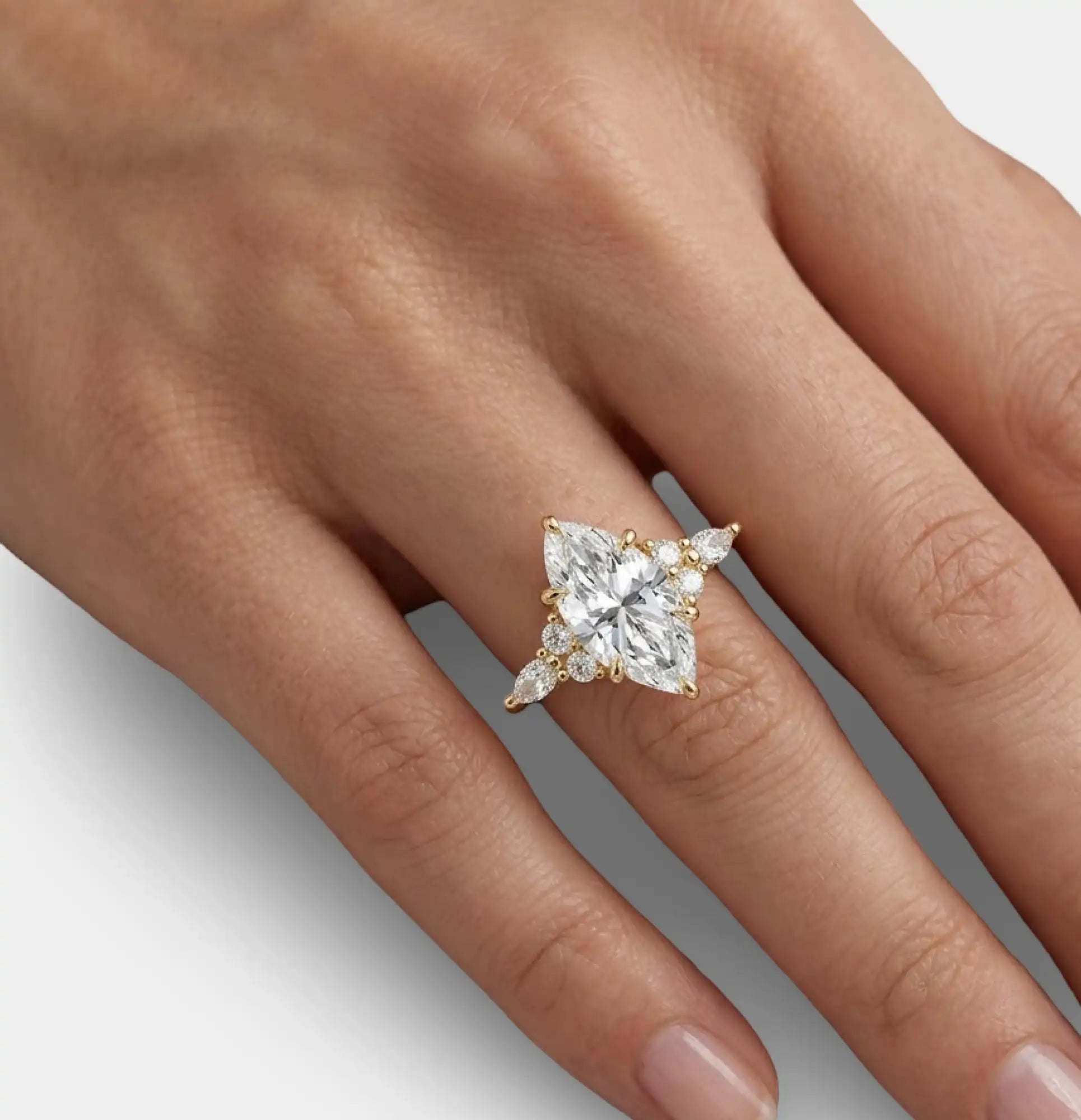 Side profile of dainty marquise engagement ring in 18K gold plating showing stone height and band proportion