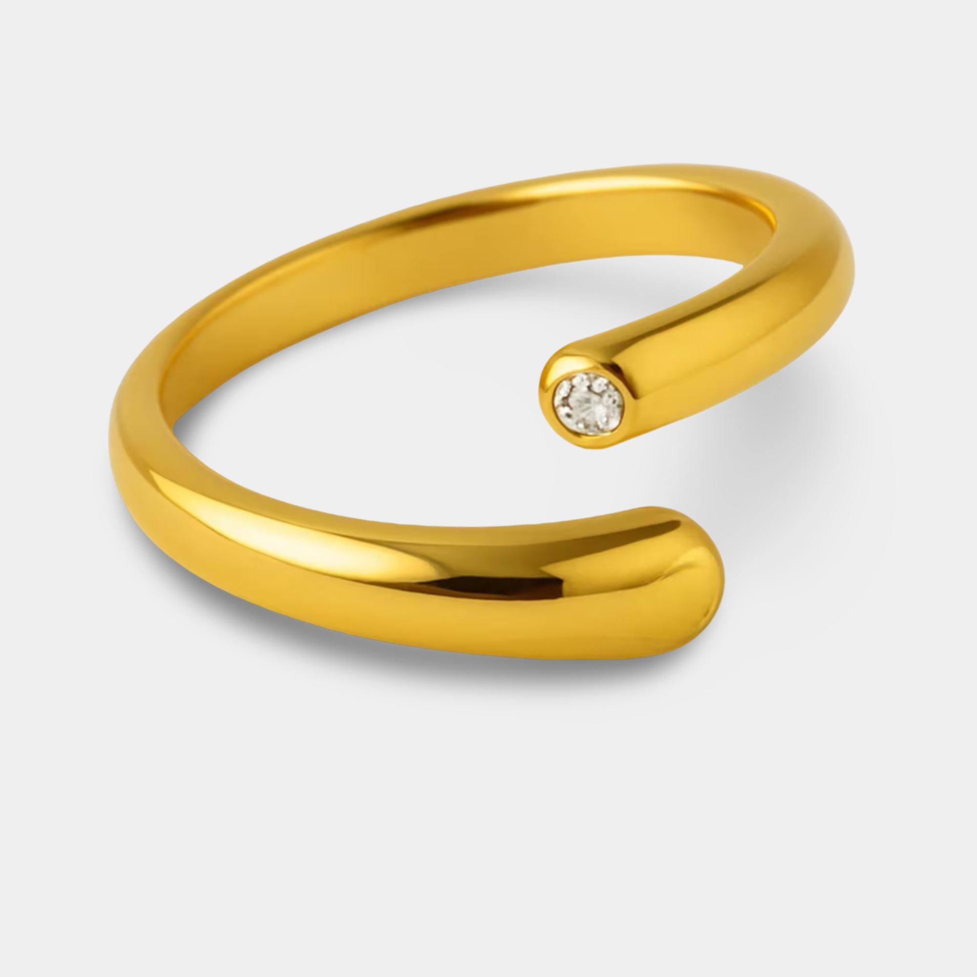 Dainty 14K gold minimalist ring worn on a woman's finger showing adjustable fit and stacking potential