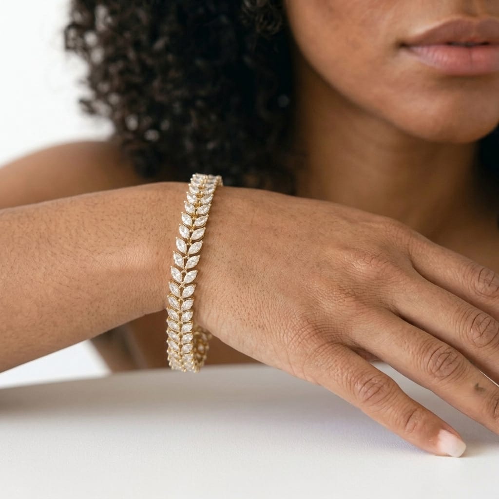 Woman wearing the MH Elegance 14K gold plated marquise cut tennis bracelet in a sparkling leaf design