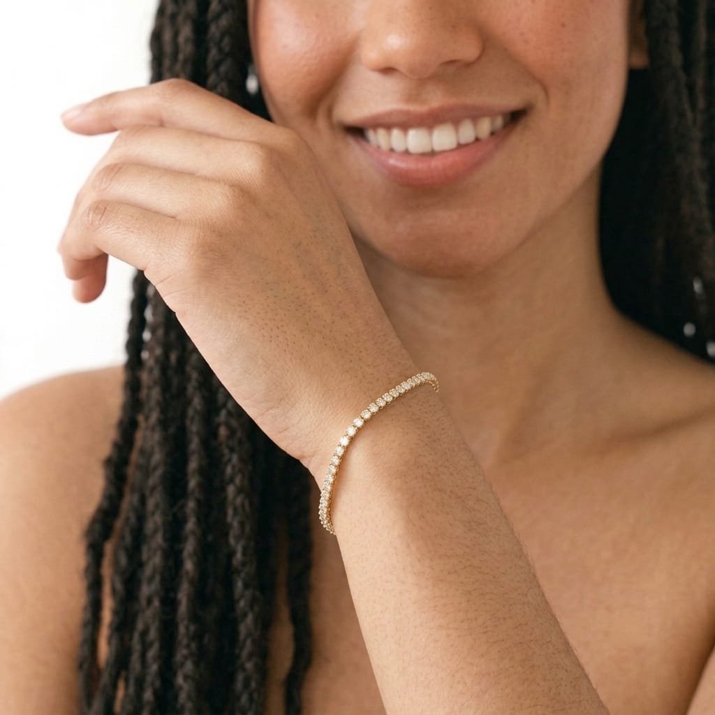 Woman smiling while wearing a 3mm cubic zirconia gold filled tennis bracelet on her wrist