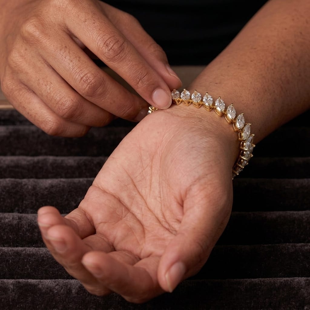Close view of the prong set marquise CZ tennis bracelet on a wrist against dark velvet
