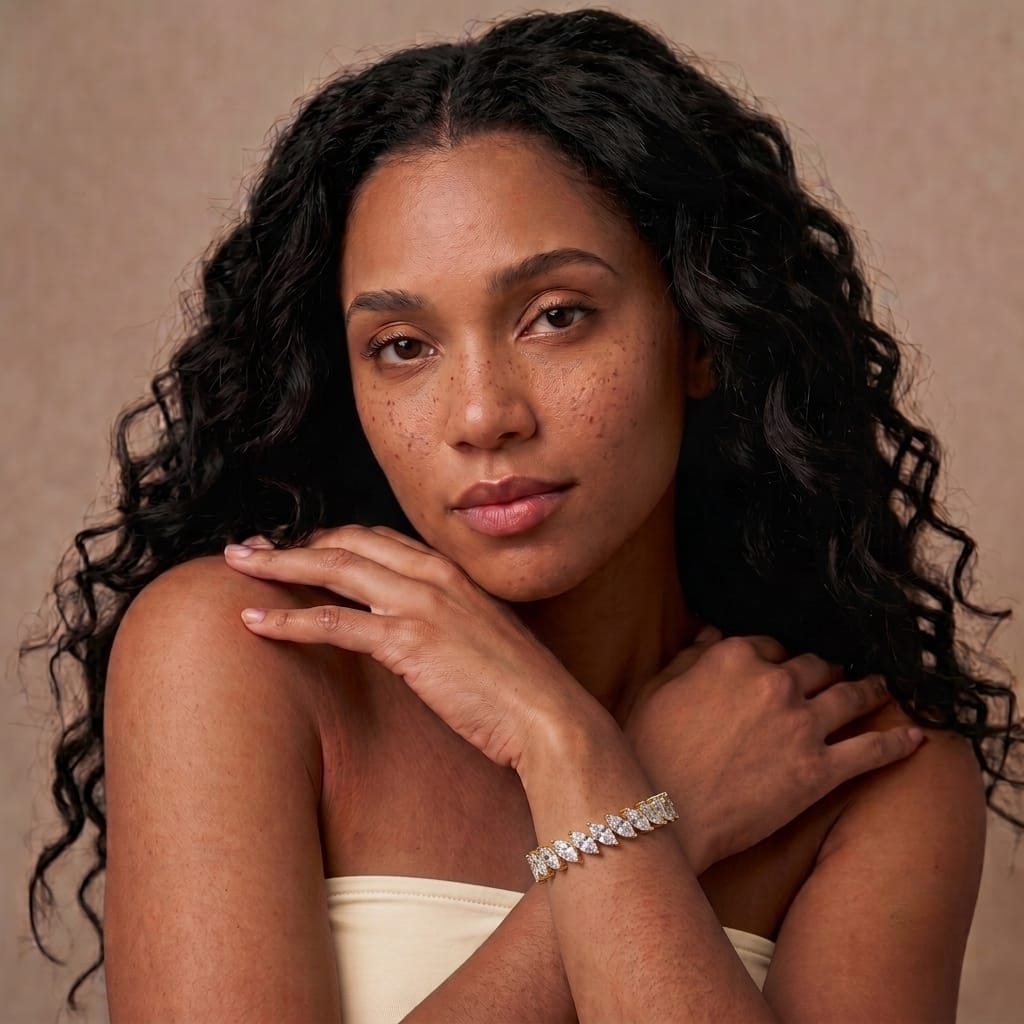 Gold plated single row marquise statement bracelet styled with a cream strapless top