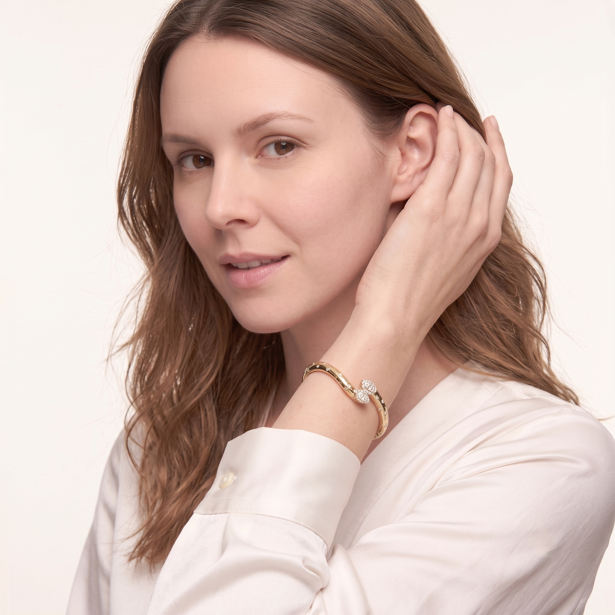 Model wearing the MH Elegance gold plated double pear CZ bangle bracelet with a white blouse