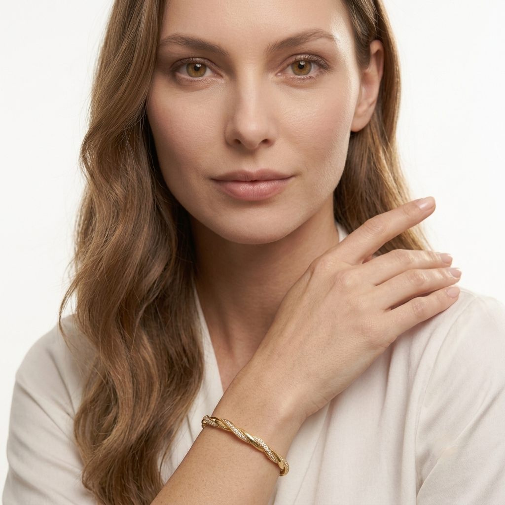 Woman wearing the MH Elegance moissanite twisted gold bangle bracelet with a white blouse