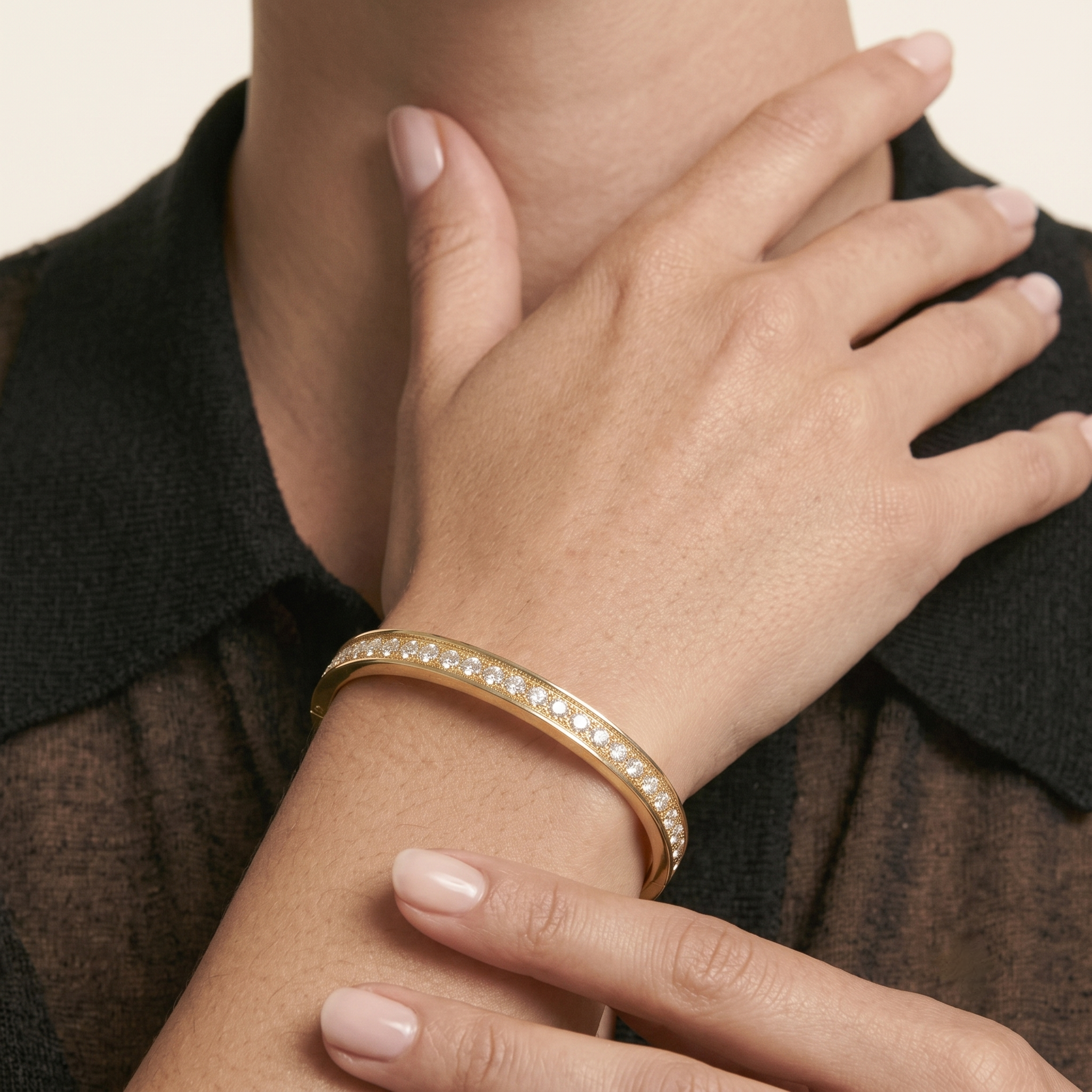 Woman touching her neck while wearing the 14K gold filled channel-set cubic zirconia eternity bangle