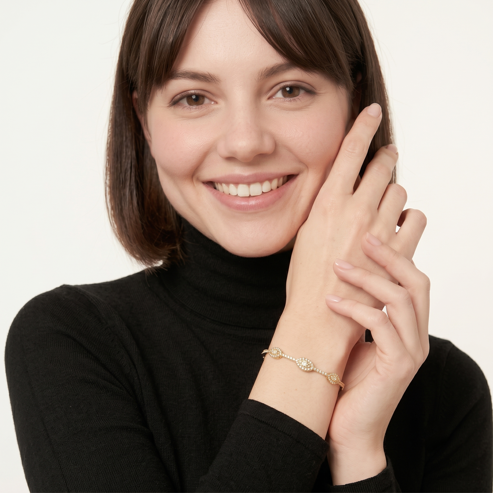 Woman wearing the gold filled evil eye bangle bracelet with round and marquise cubic zirconia stations