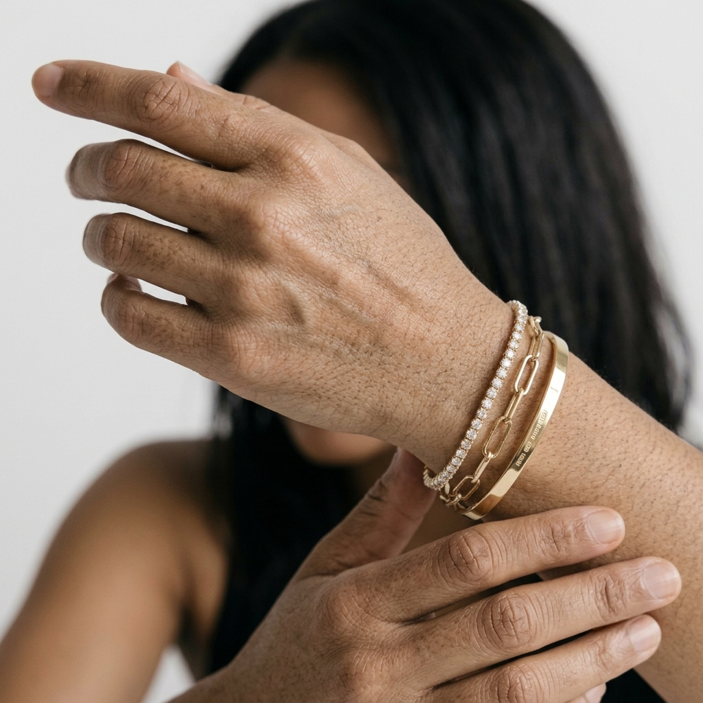 Three piece gold bracelet stack with a cubic zirconia tennis bracelet and paperclip link chain