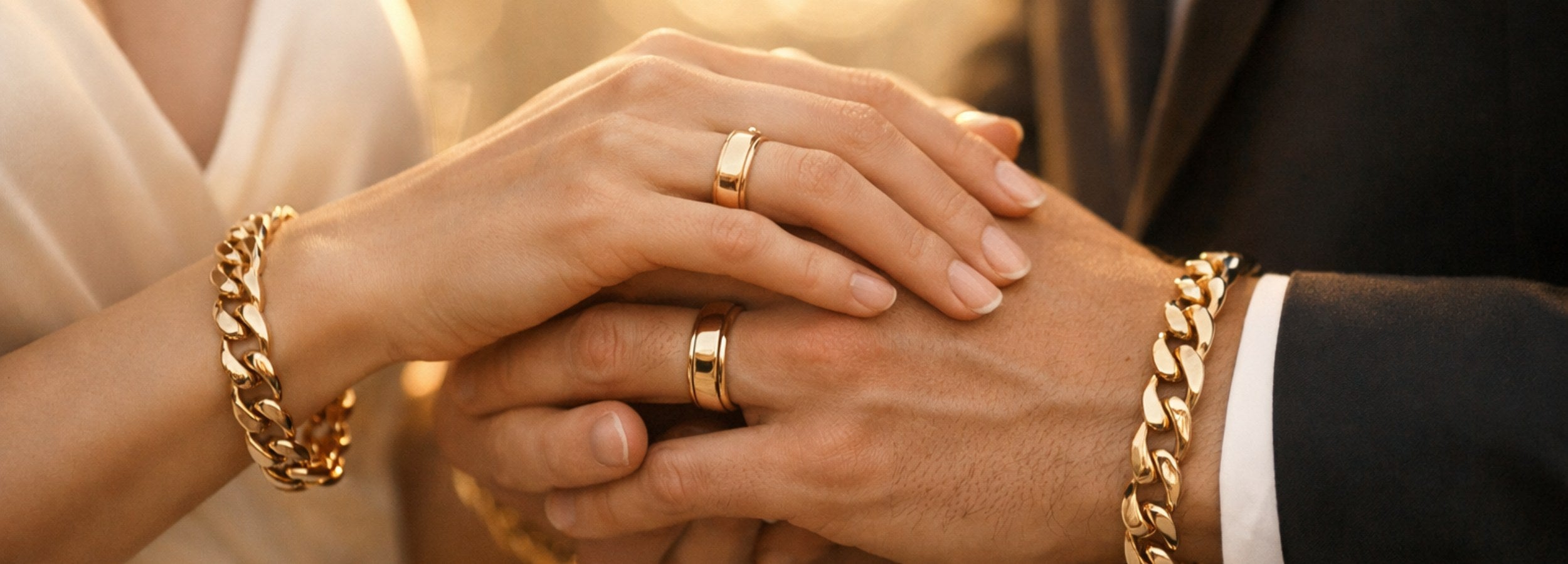 Couple holding hands wearing matching MH Elegance gold rings and bracelets — fine jewelry for life's meaningful moments