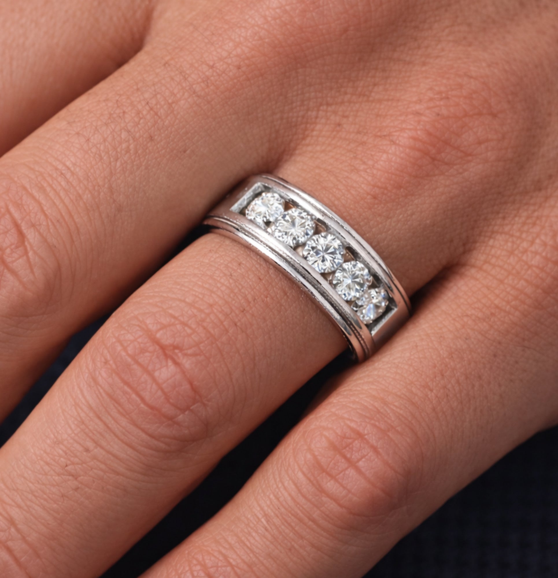 Side profile of the MH Elegance moissanite eternity band showing the channel setting
