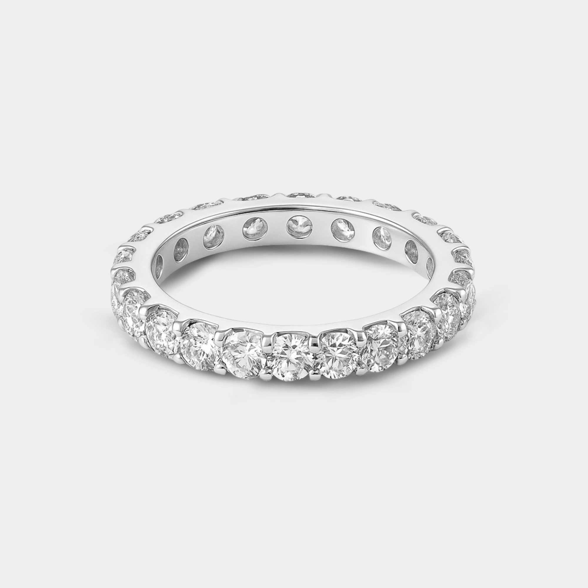 Macro close-up of the white gold eternity ring showing the clear cubic zirconia stones and shiny rhodium finish