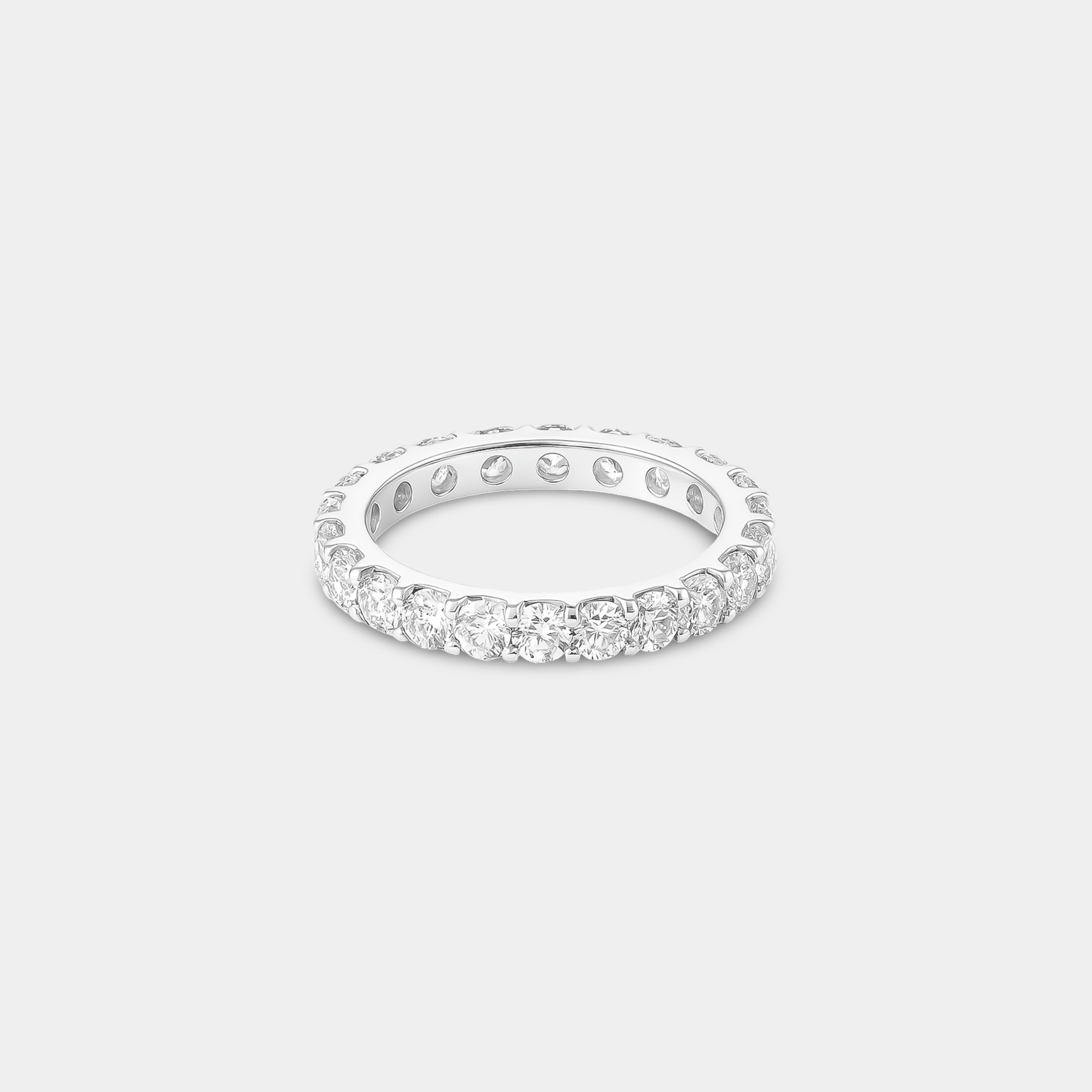 Side angle view of the slim white gold cubic zirconia eternity ring showing its comfortable low profile