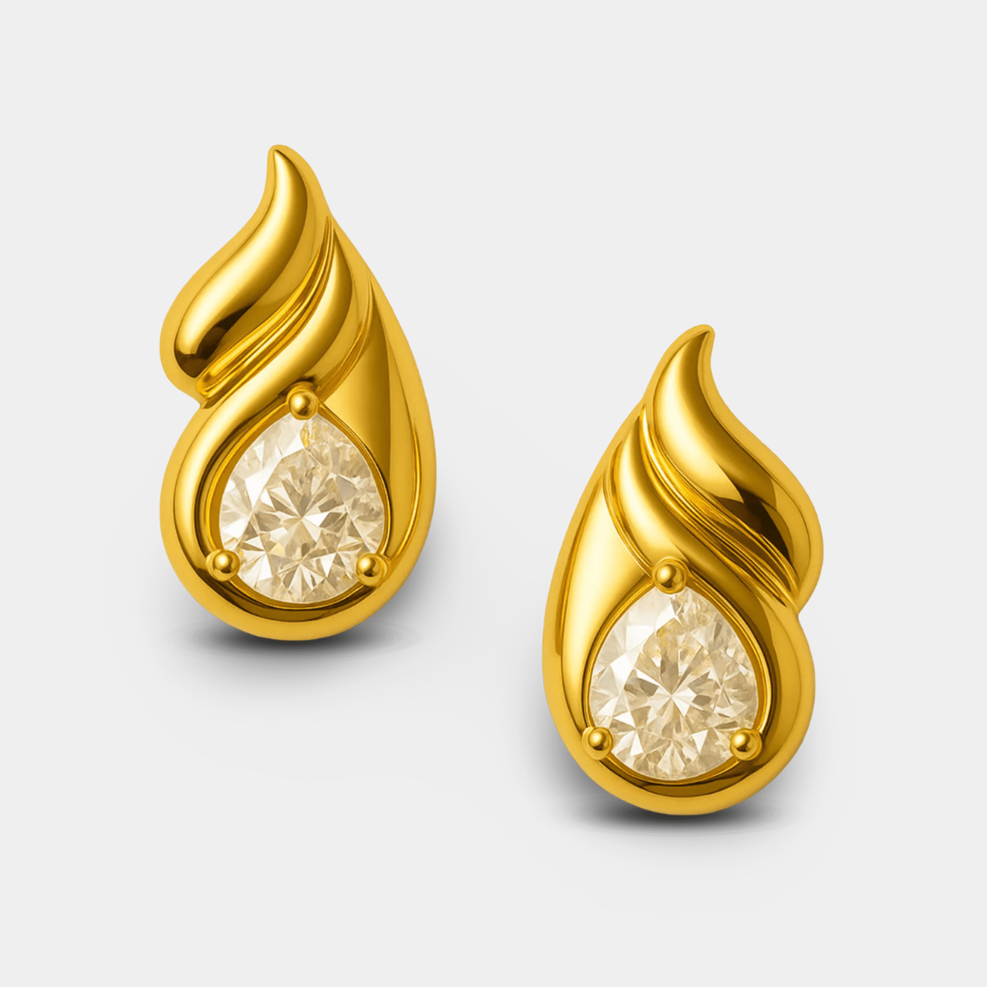 Pair of gold double teardrop stud earrings shown side by side.