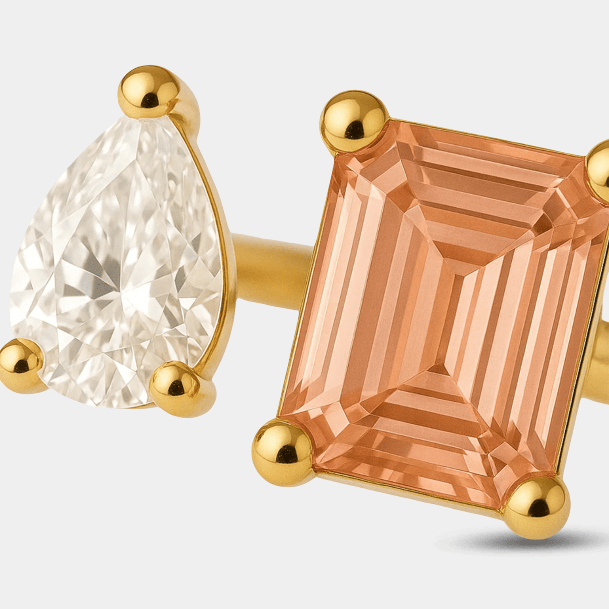 Close-up of the two square zircon stones on a gold open ring