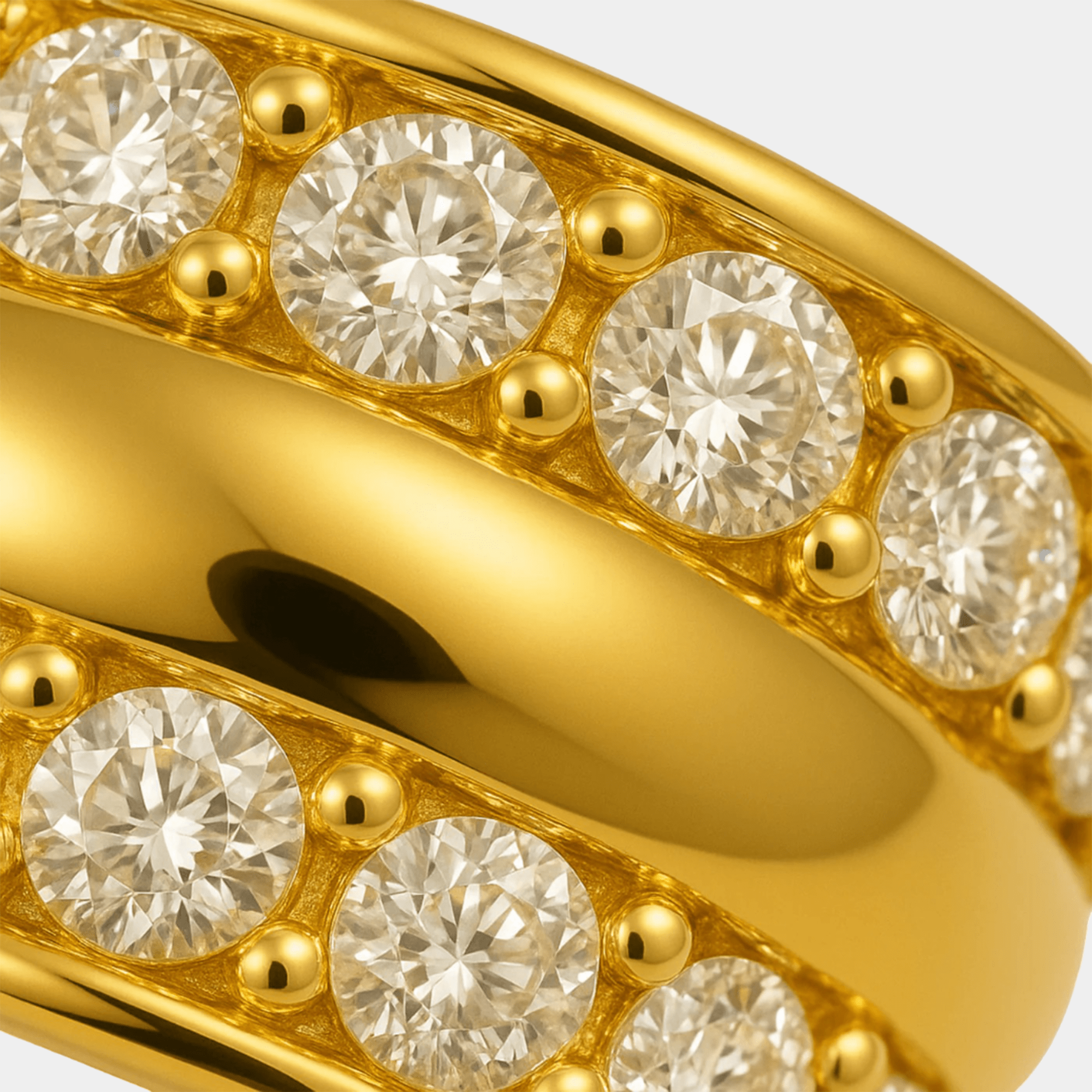 Macro close-up of the channel-set cubic zirconia stones and gold bead detail along both rows of the ring