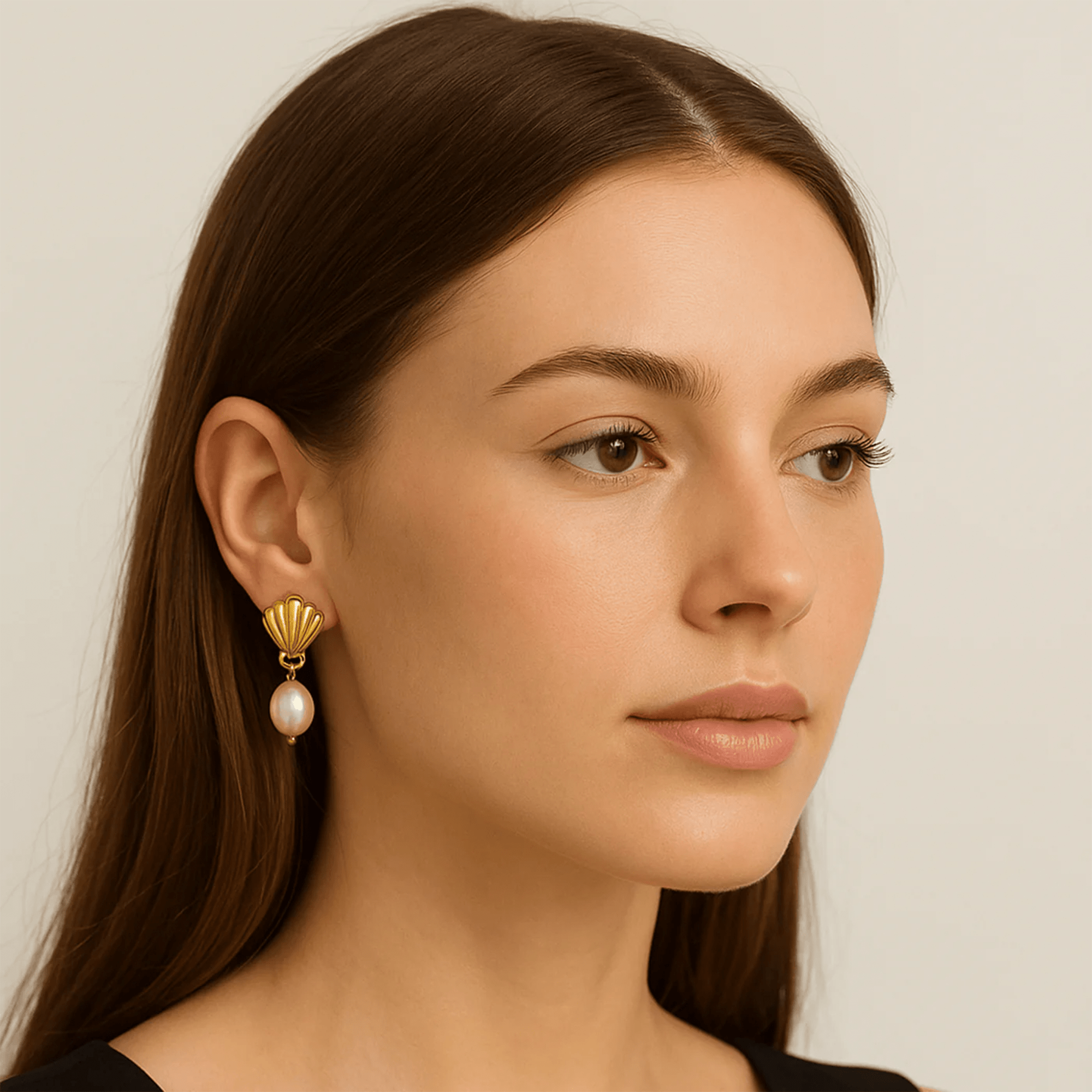 Glam Shell gold drop earrings size reference next to a coin for scale