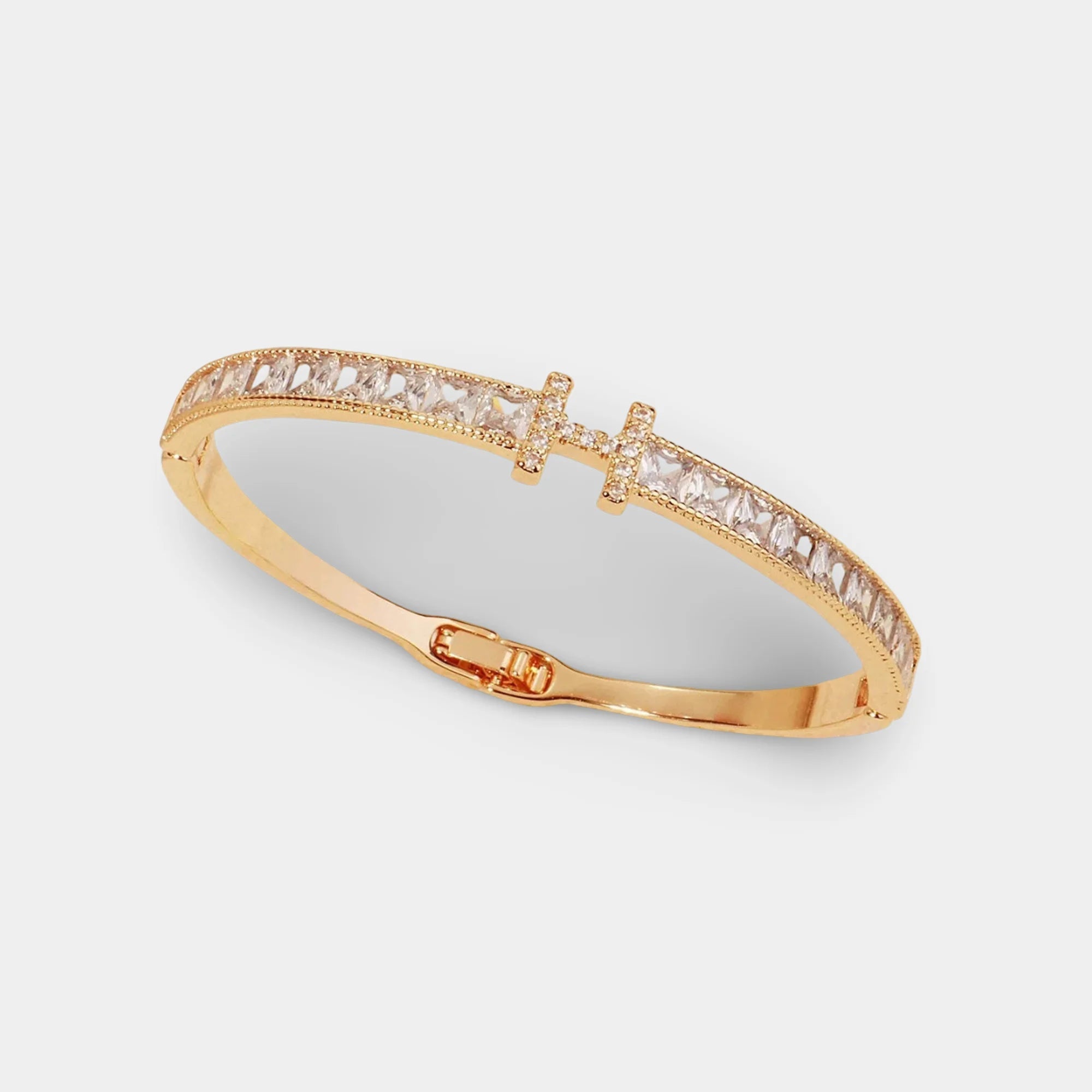 Close-up of the H letter and cubic zirconia stones on a gold bangle