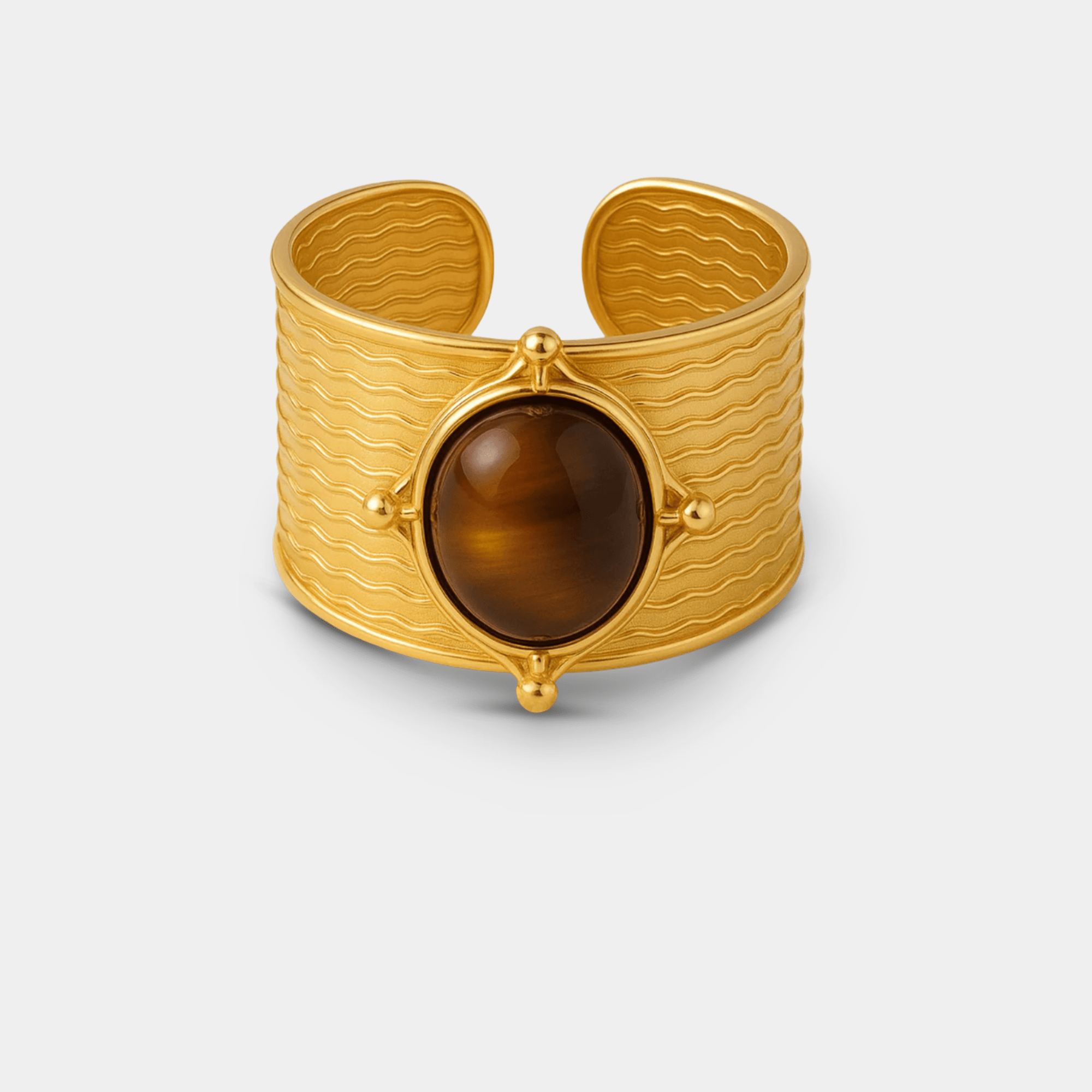 Front view of the adjustable open-back gold cuff ring with an oval tiger's eye centerpiece