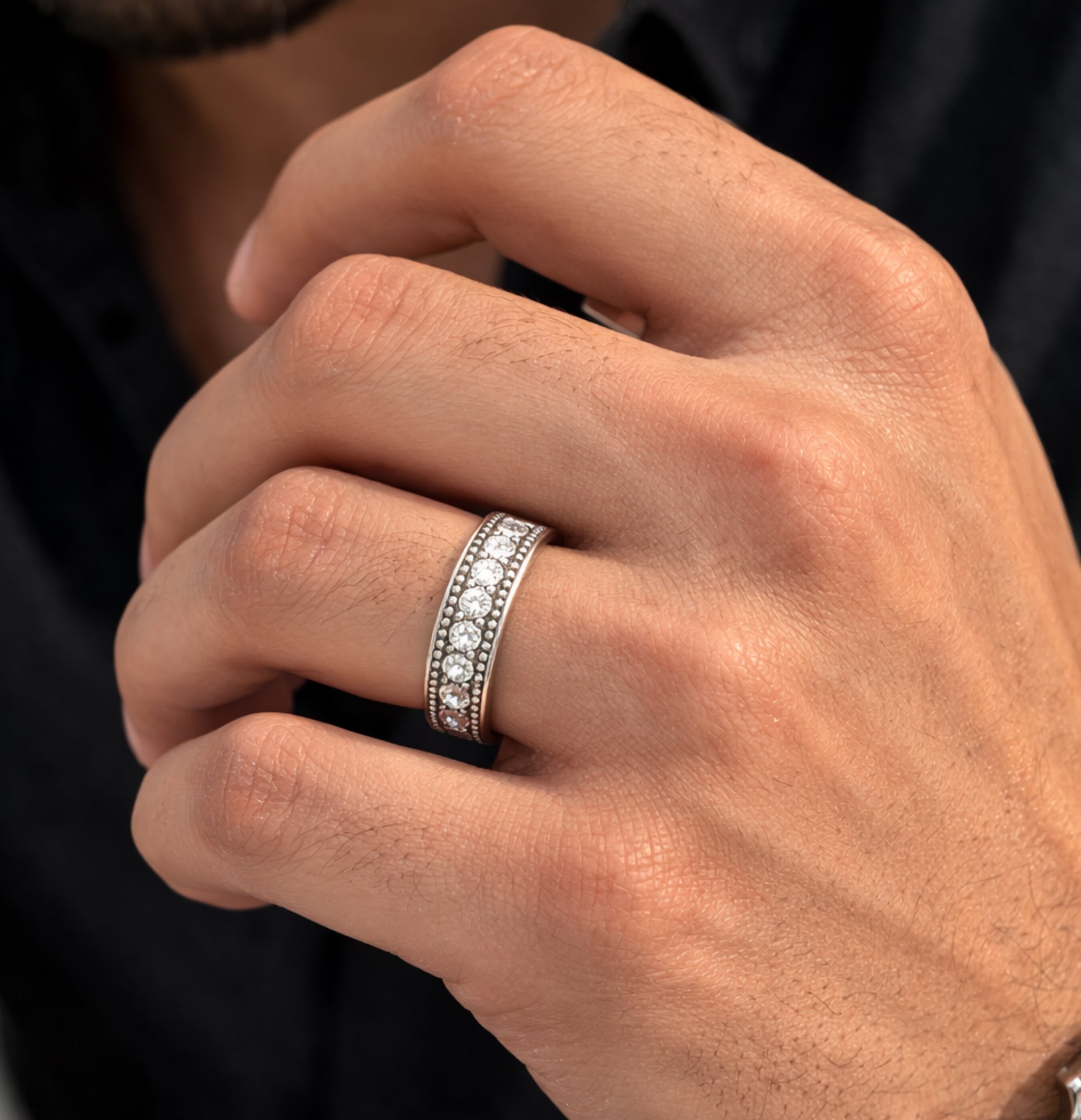 Close view of the sparkling round moissanite on the silver ring