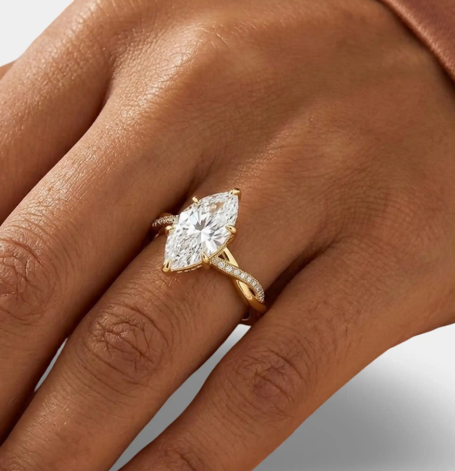 Close-up of a D color VVS marquise moissanite center stone in a white gold prong setting