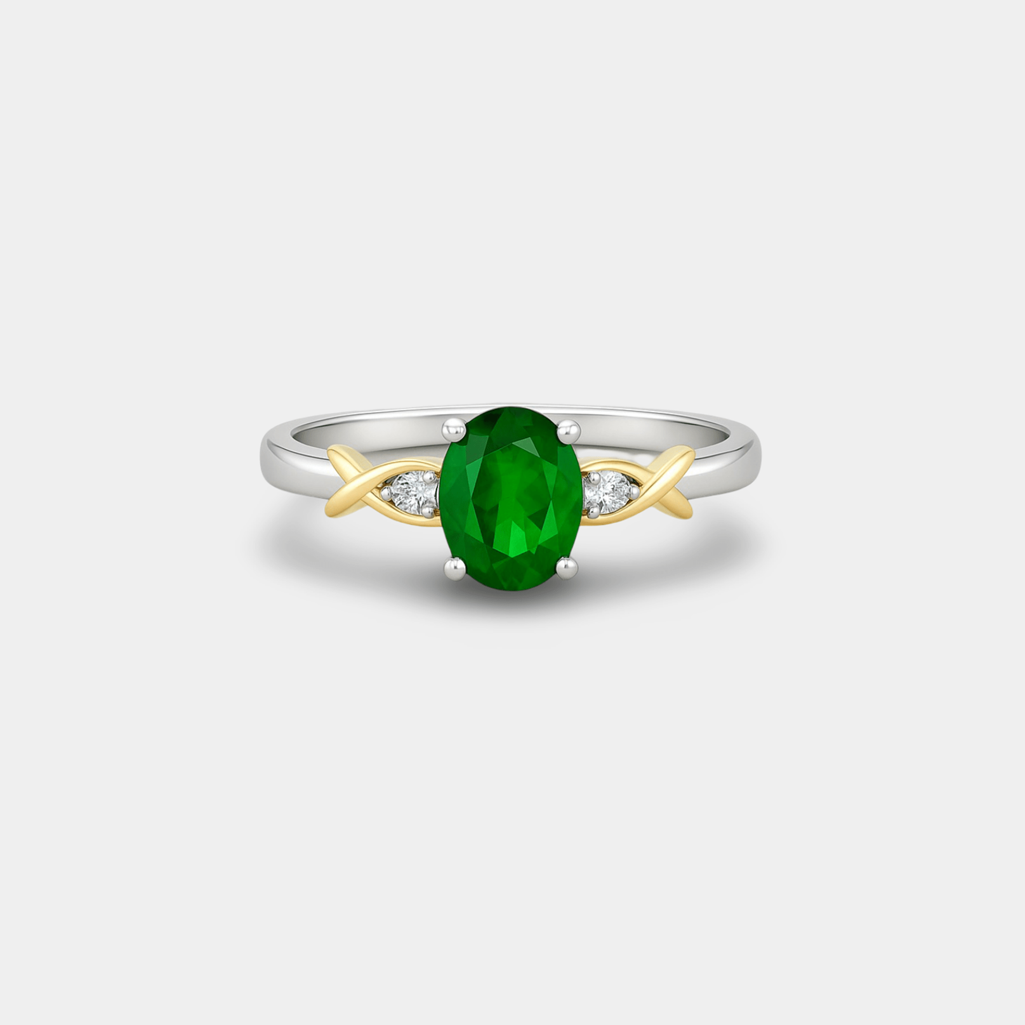 Close-up of green nano emerald center stone and round diamond accents on crossover ring