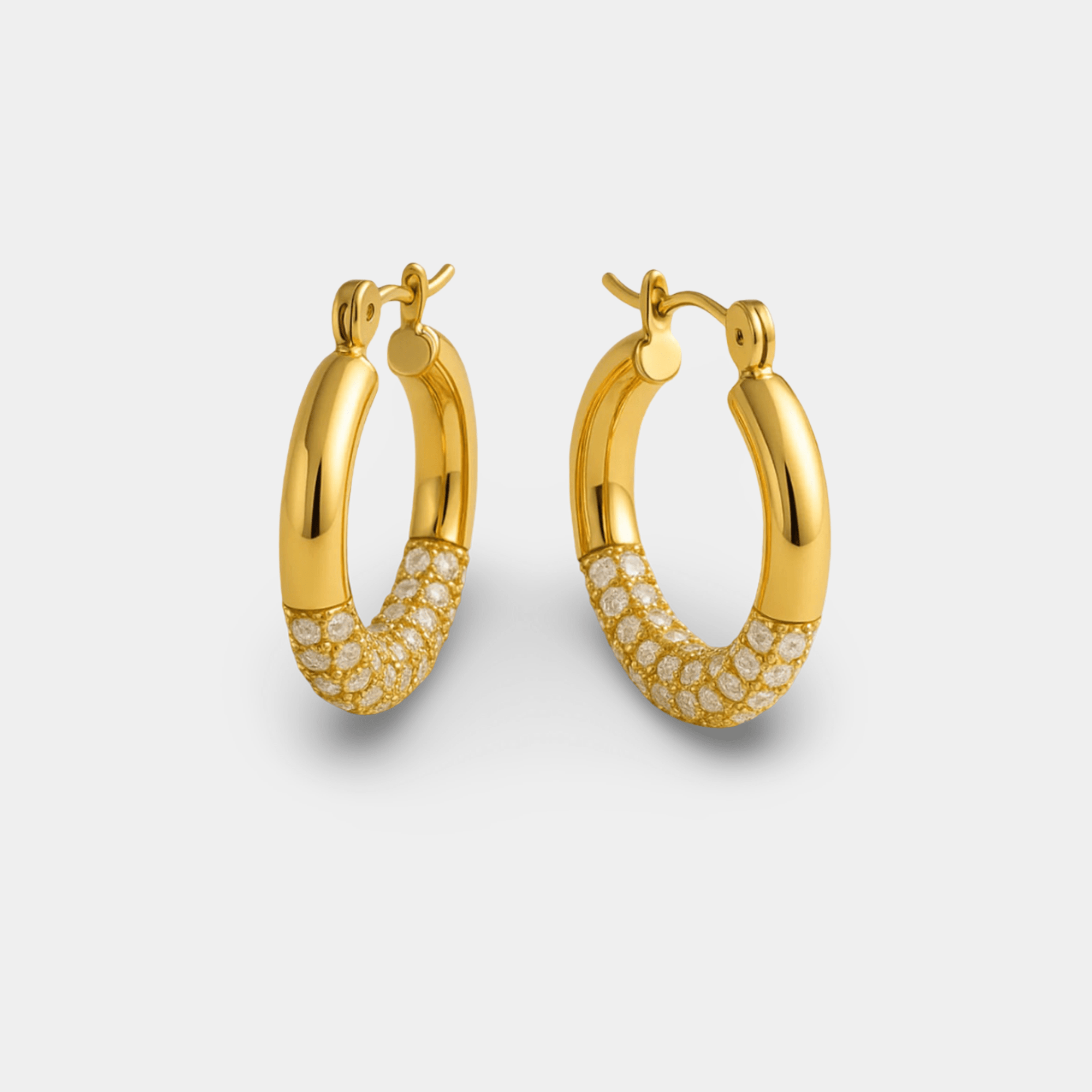 Titanium steel gold hoop earrings with sparkling rhinestone pavé inlay in a tilted display view