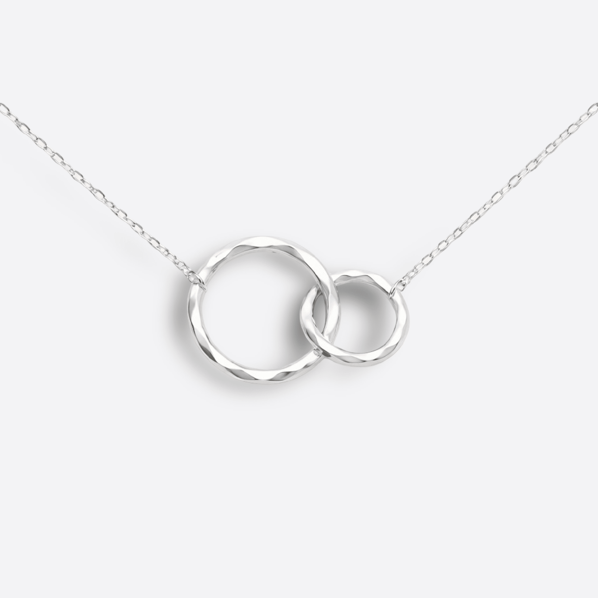 Close-up of the hammered interlocking circles pendant on a sterling silver maid of honor necklace