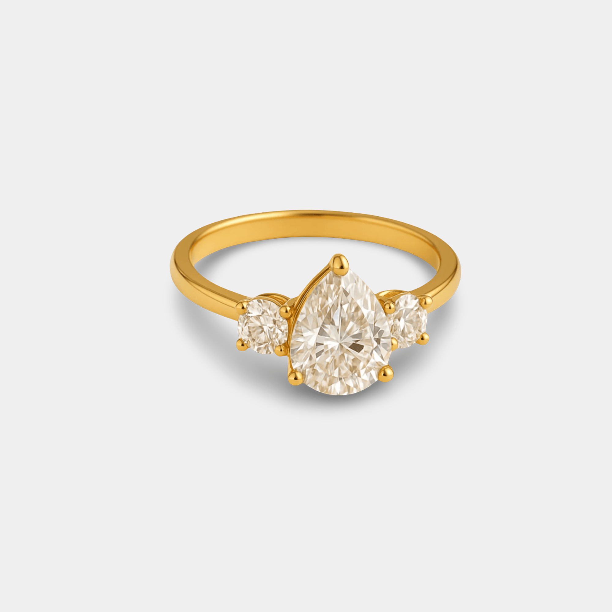 Detailed front view showing the sparkle and clarity of the pear-cut center stone on the gold ring