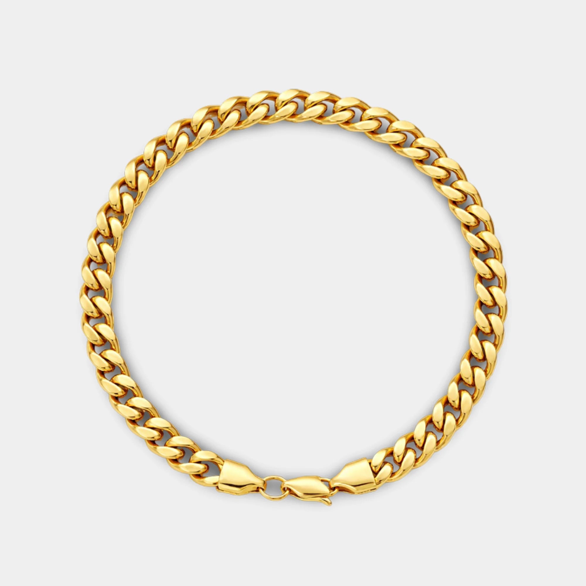 Close-up of the flat diamond-cut Miami Cuban links on the gold bracelet showing the shiny polished finish