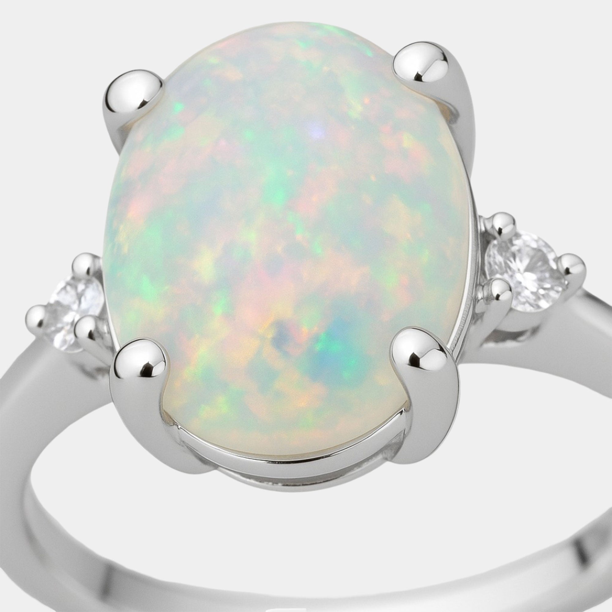 Opal three-stone ring shown from the side on a sterling silver band.