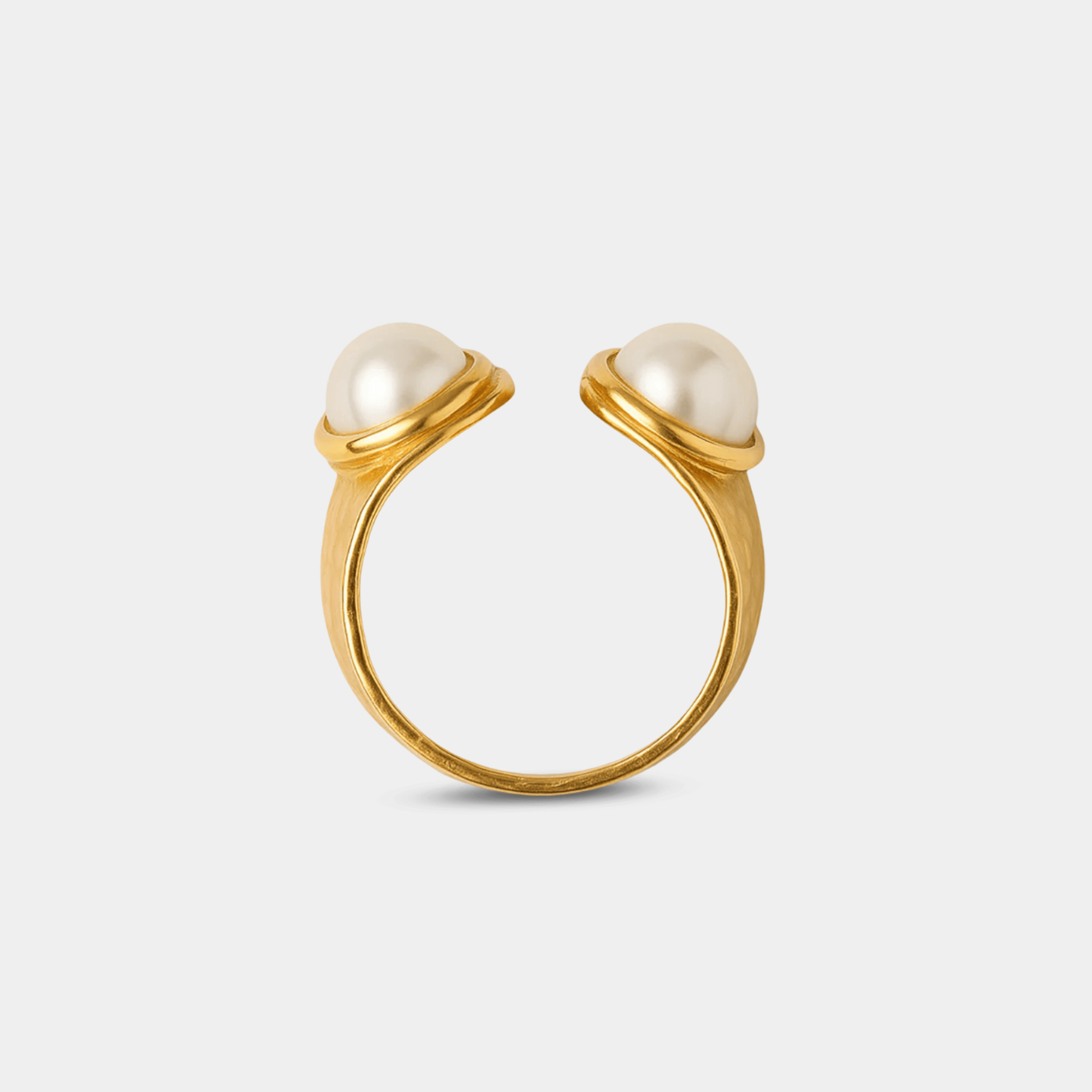 Close-up of the duo pearl ring showing the cultured freshwater pearl setting and zircon accents on the gold band