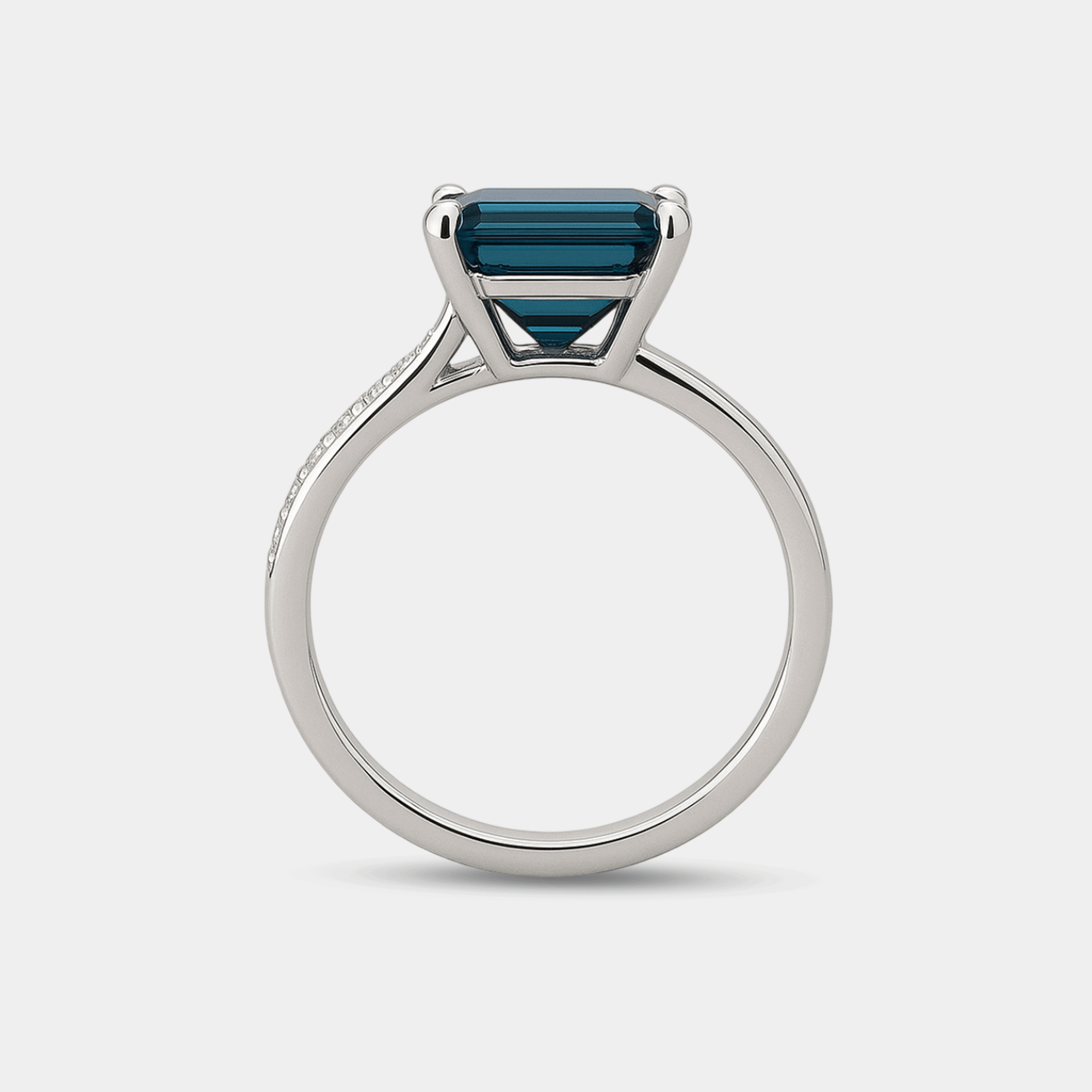 Side angle view of the blue topaz halo ring in sterling silver