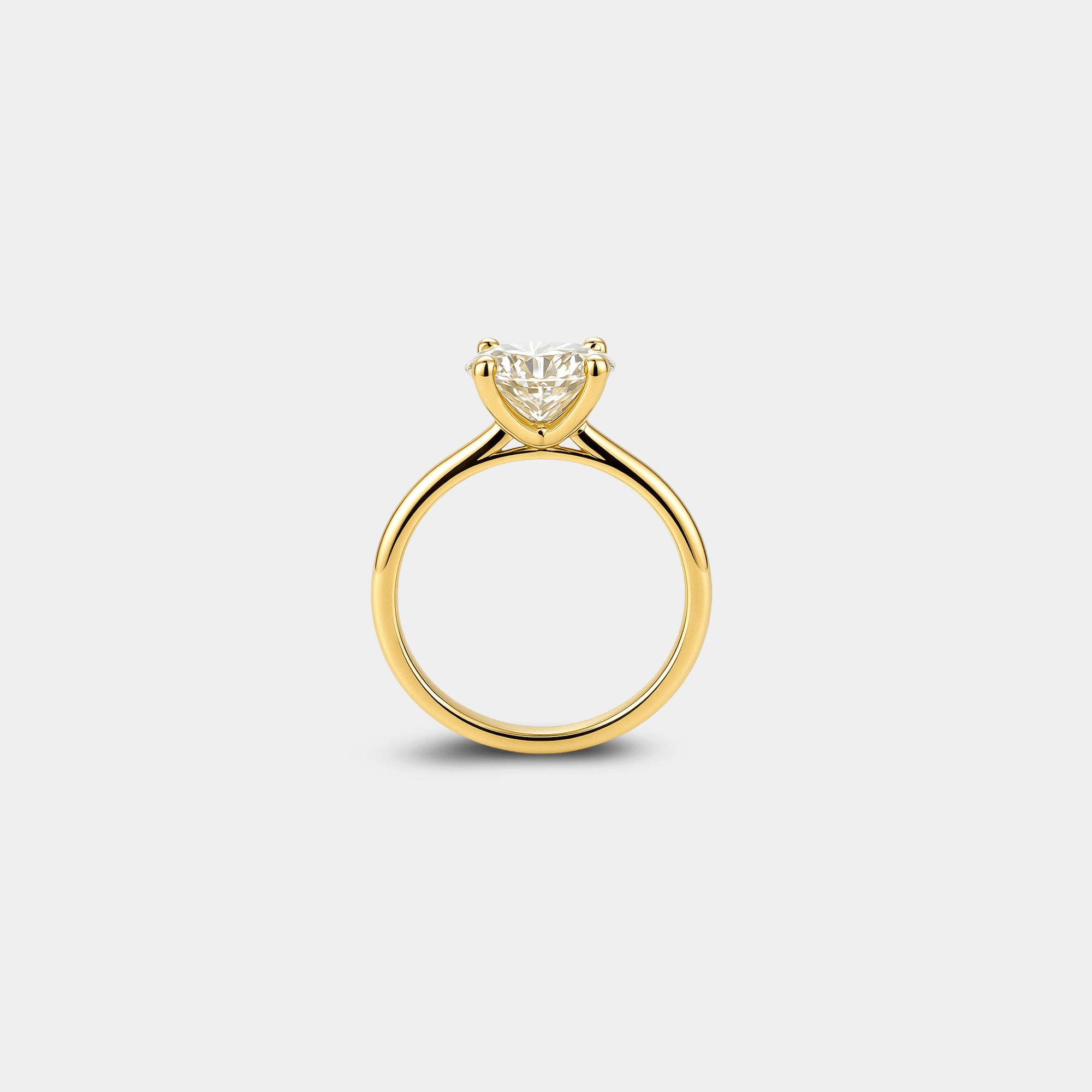 Yellow gold plated sterling silver moissanite solitaire ring shown at an angle to show its brilliance