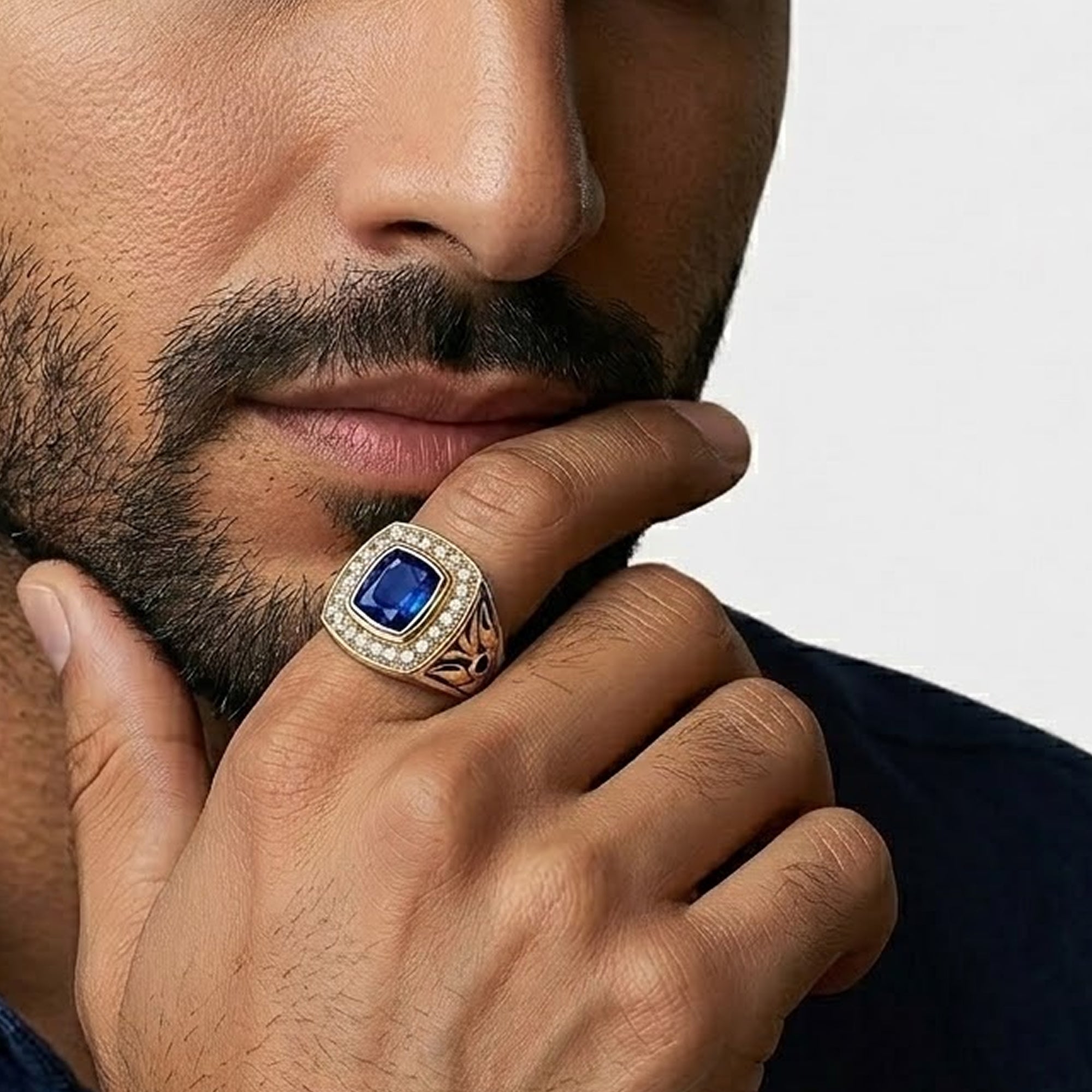 Close-up of the square blue stone on a two tone men's cocktail ring